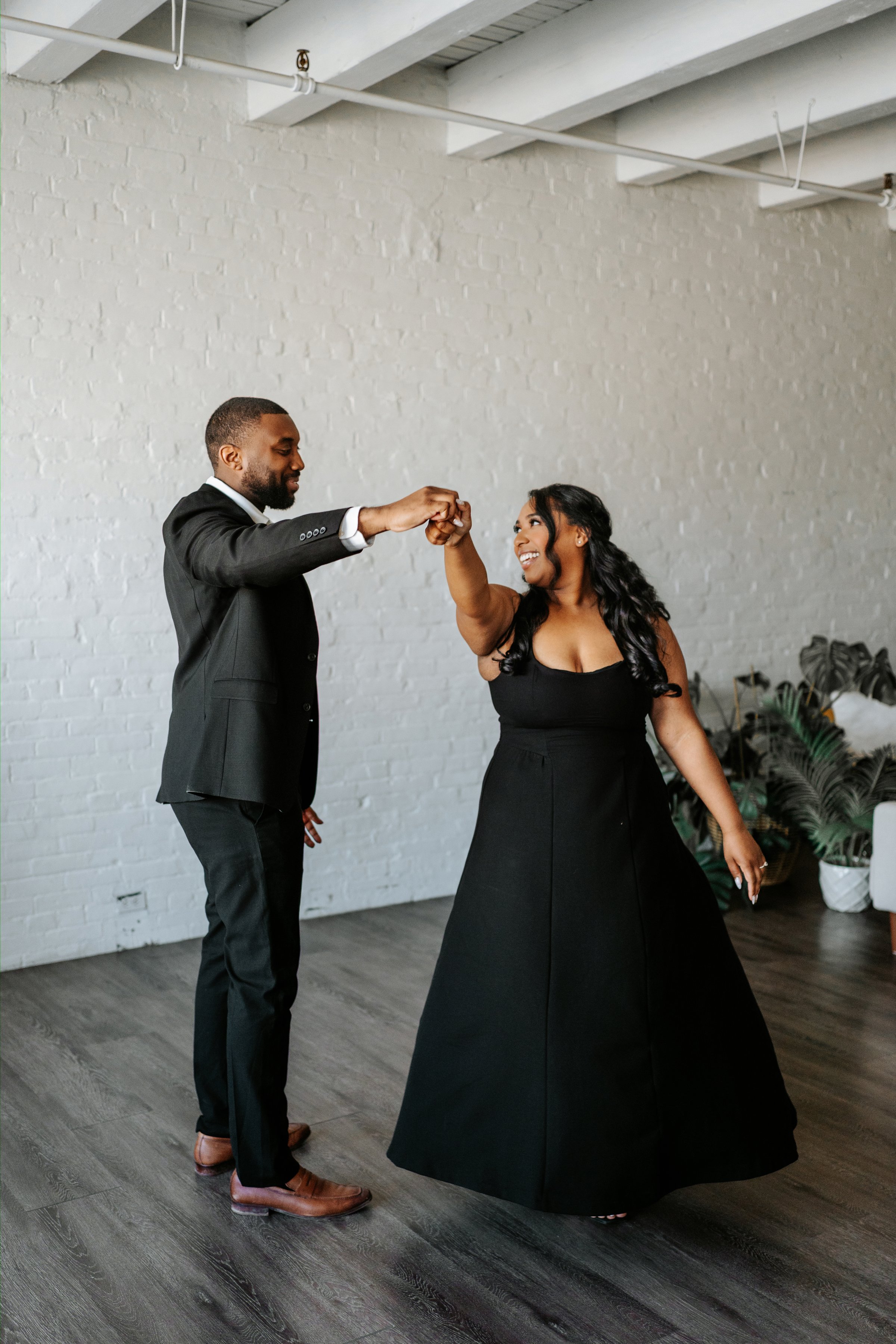 Jaida and Jordan candid moment on a downtown Winnipeg street — engagement photography by Ngo Photography