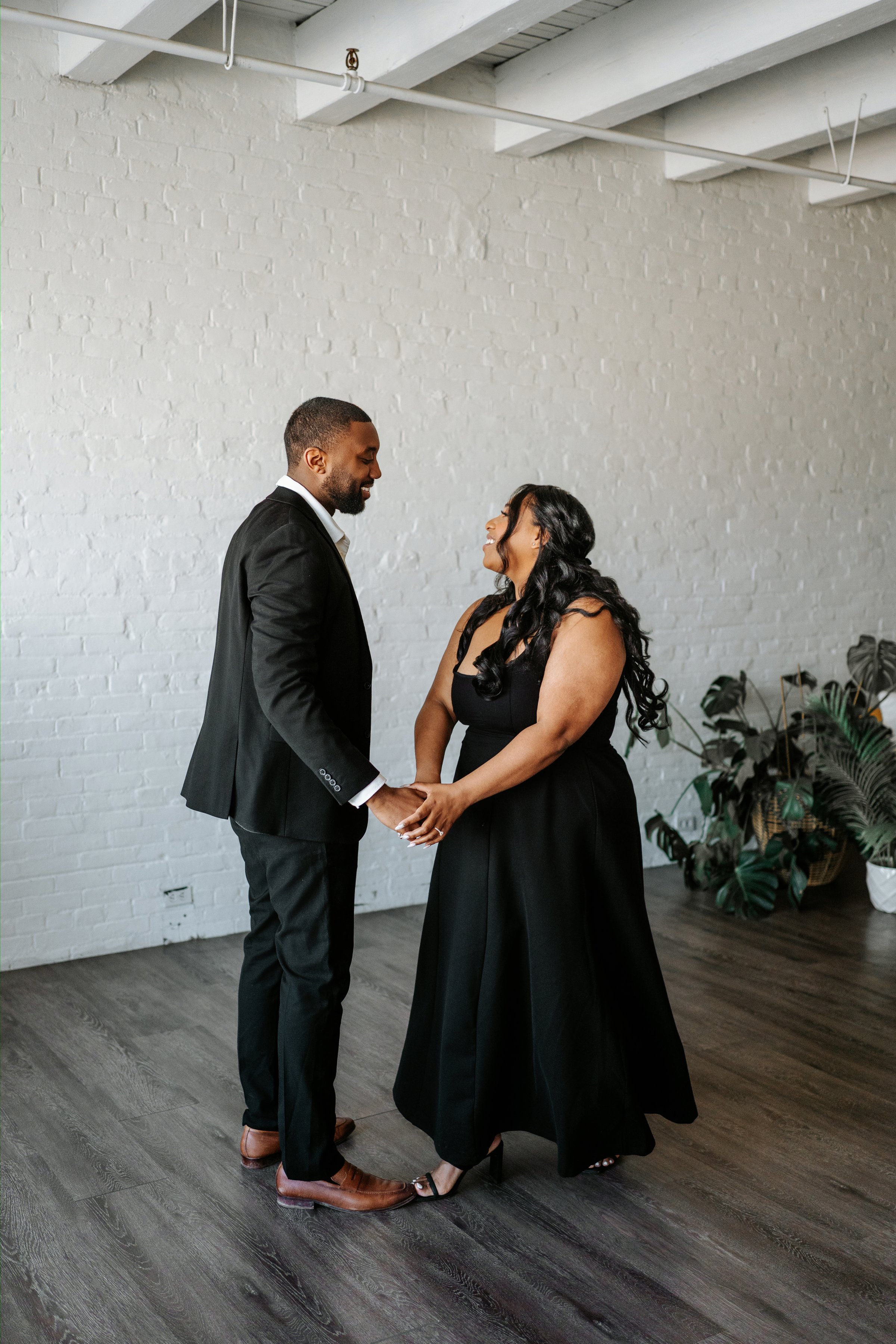 Jaida and Jordan portrait with downtown Winnipeg architecture — engagement photography by Ngo Photography