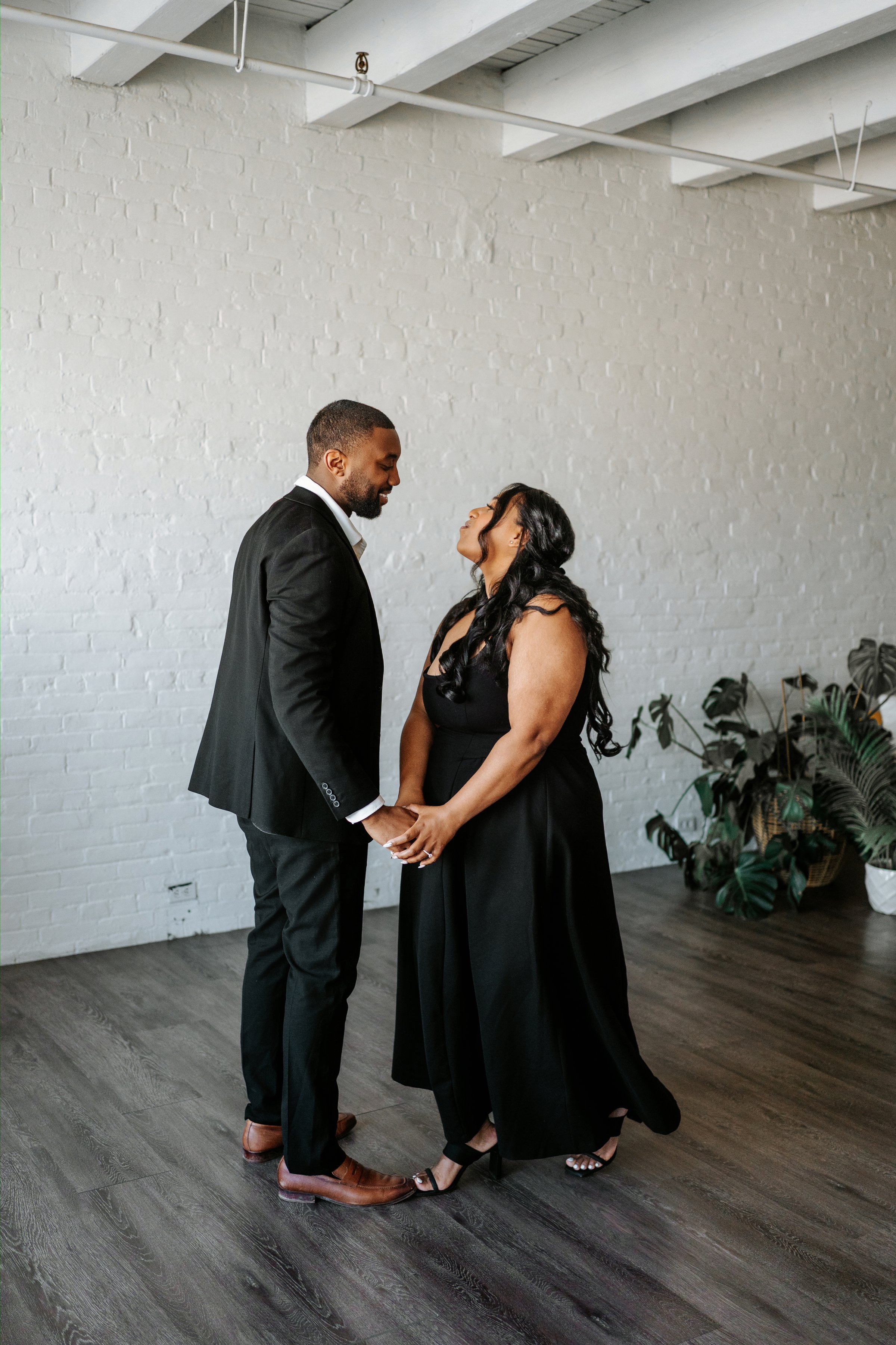 Jordan and Jaida walking through the downtown Winnipeg core — engagement photography by Chris Ngo
