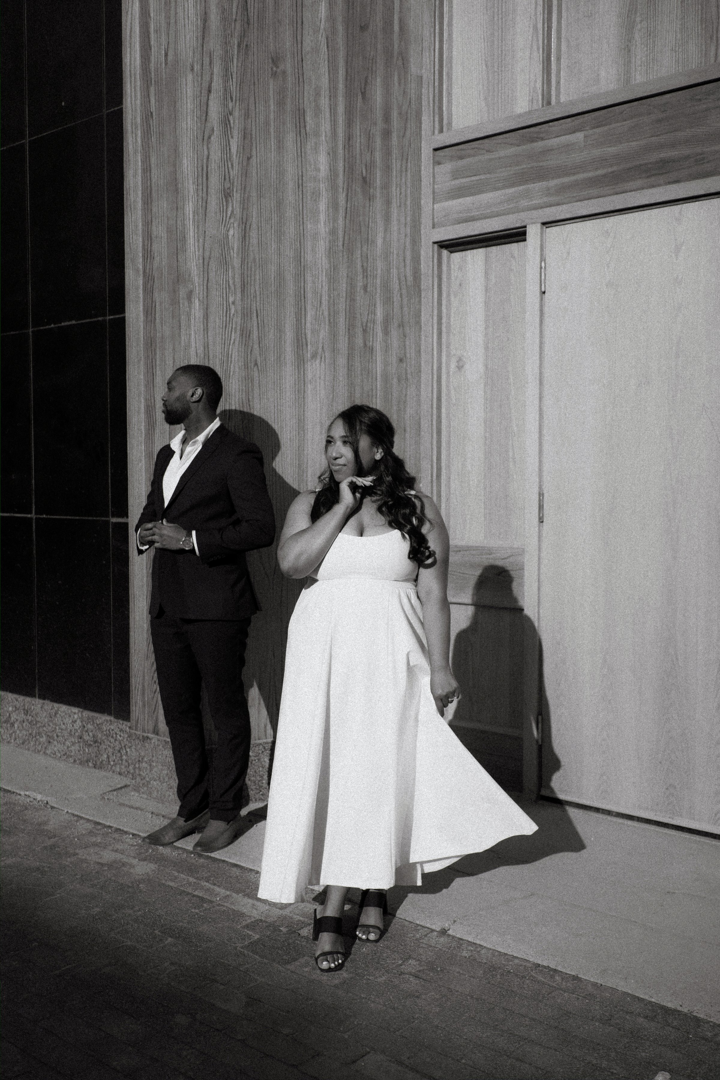 Jordan holding Jaida at sunset on a downtown Winnipeg parkade — engagement session photography by Ngo Photography