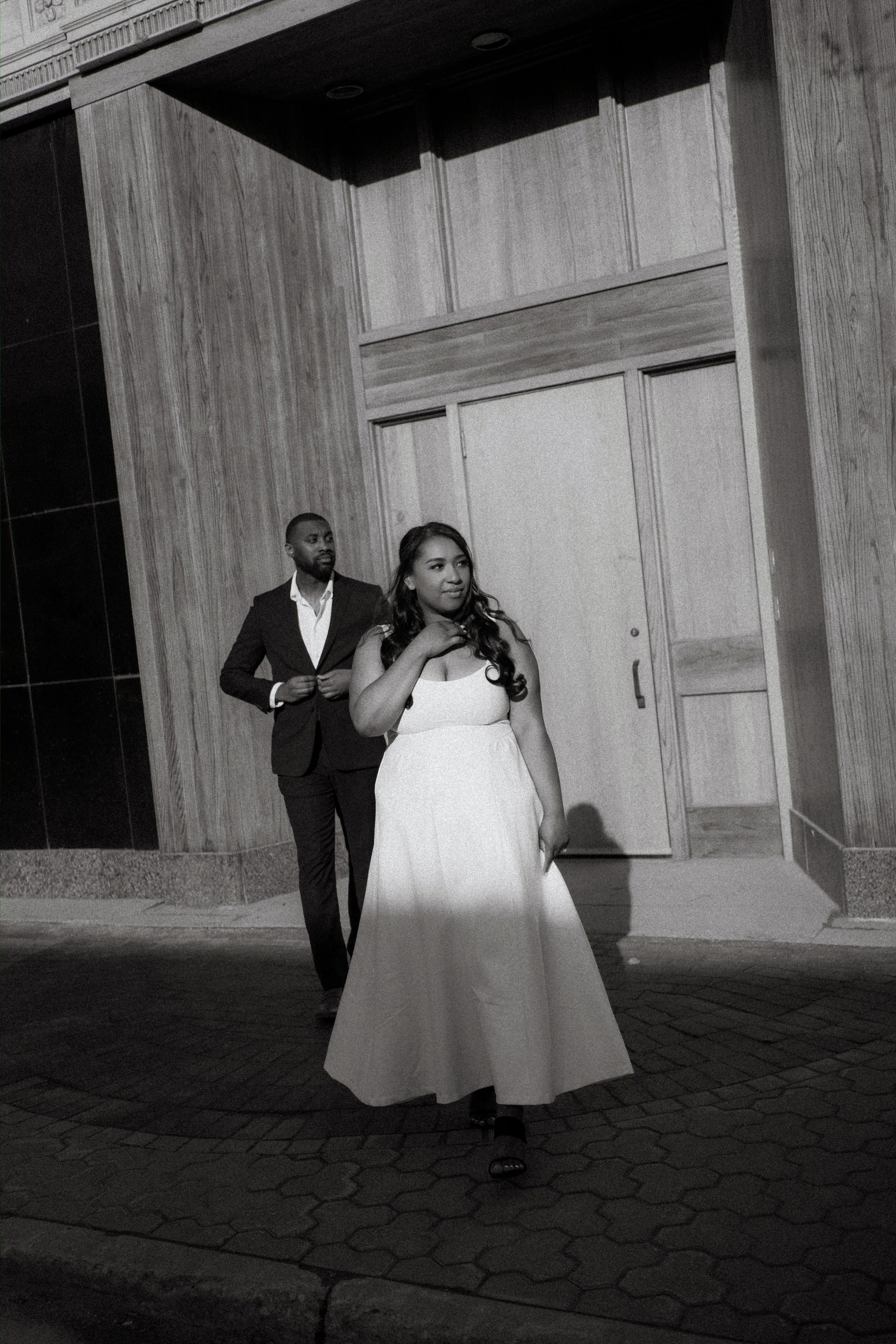 Jaida and Jordan kissing at golden hour on a downtown Winnipeg parkade — engagement photography by Ngo Photography