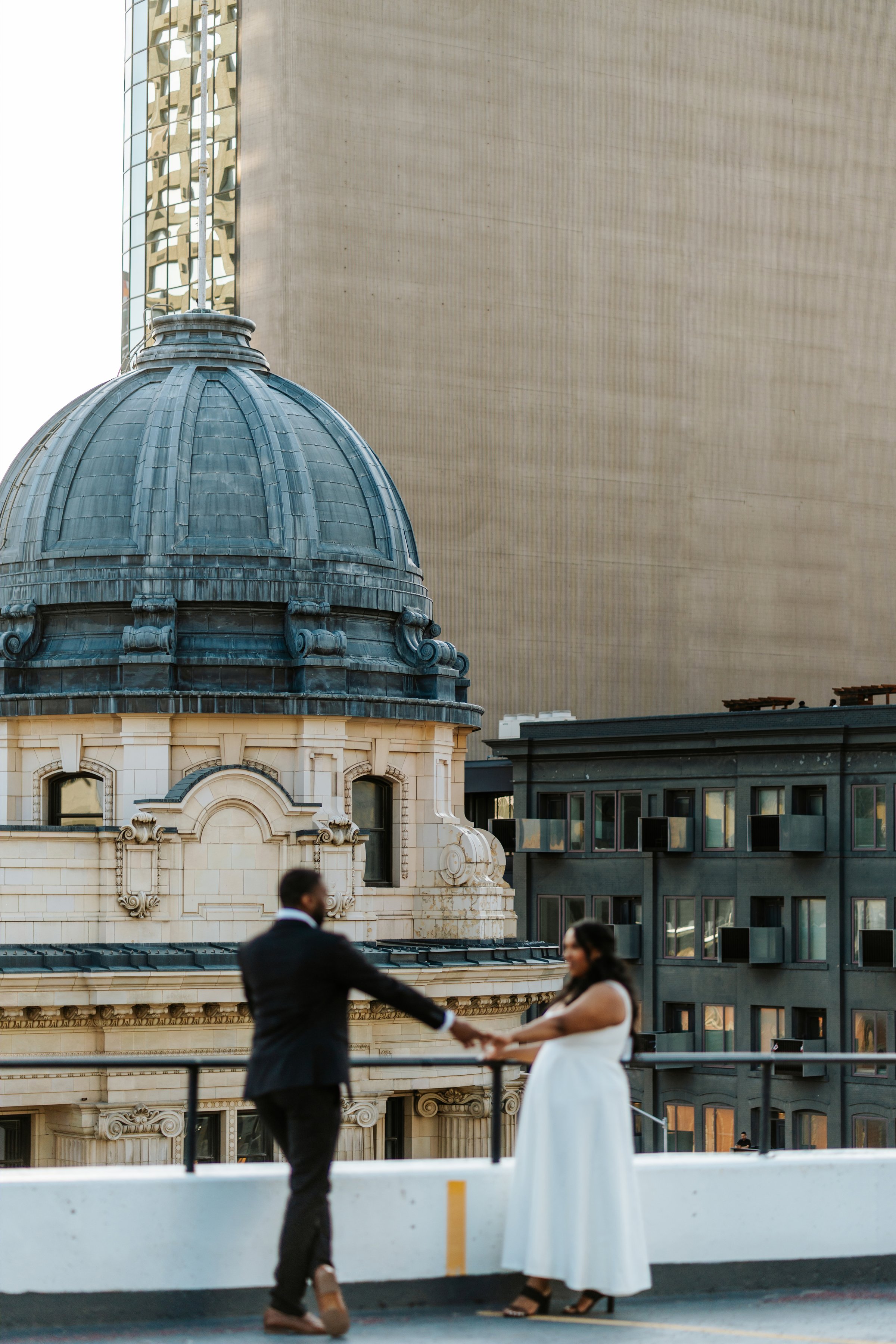 Jaida and Jordan portrait at sunset on a downtown Winnipeg parkade — engagement photography by Chris Ngo