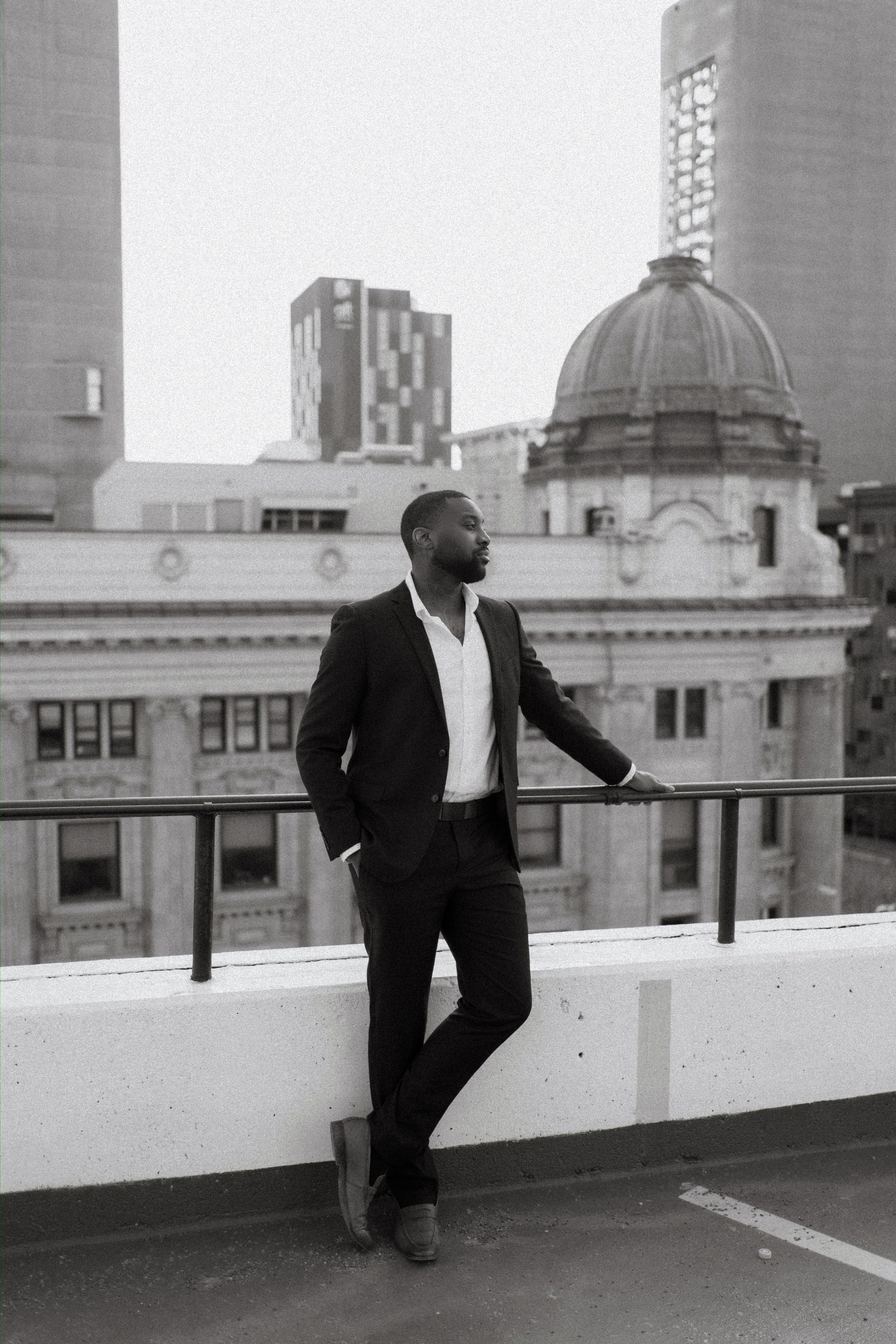Jordan and Jaida at golden hour on a Winnipeg parkade rooftop — engagement photography by Ngo Photography