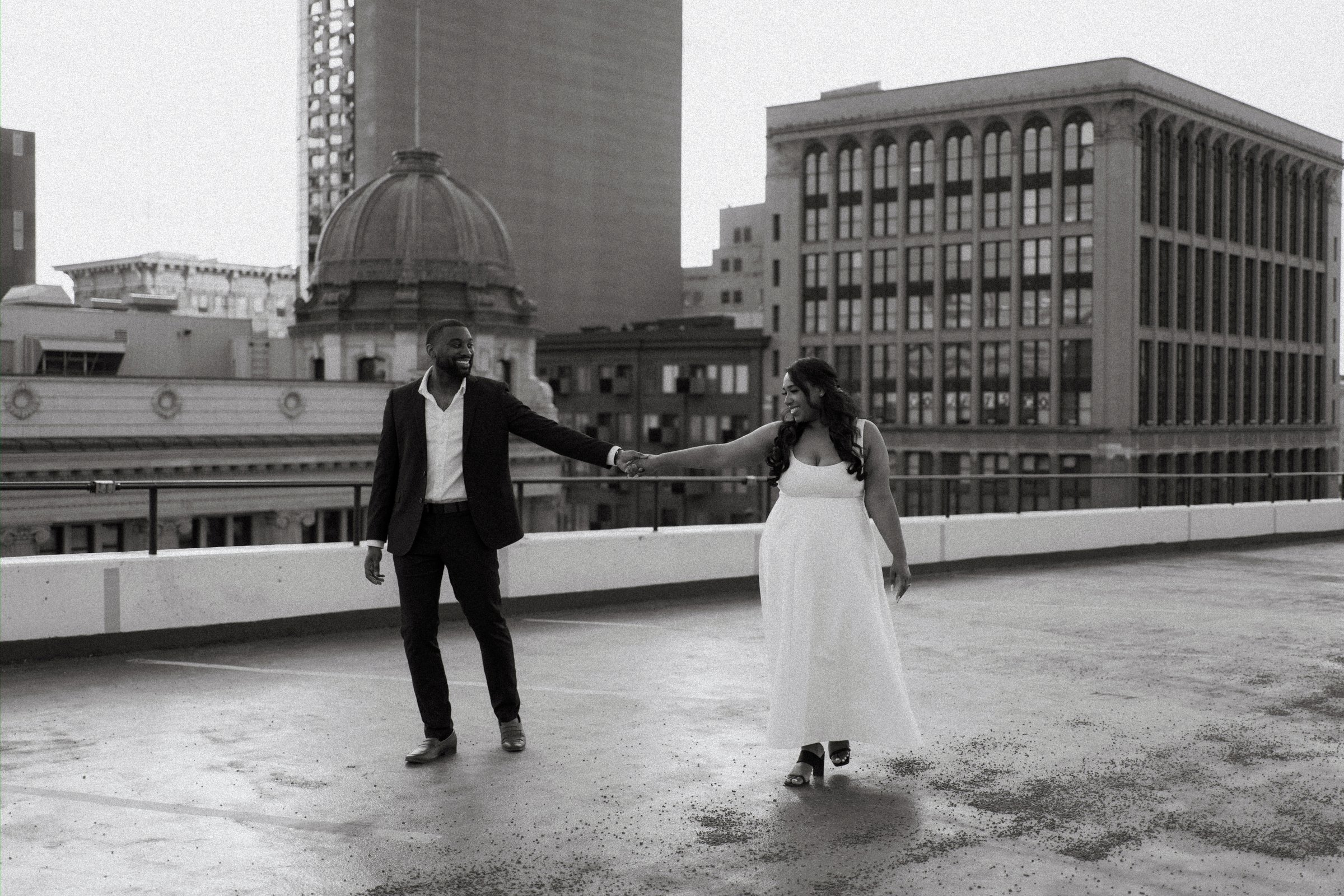 Jaida and Jordan close portrait in the warm sunset light on a Winnipeg parkade — engagement photography by Ngo Photography
