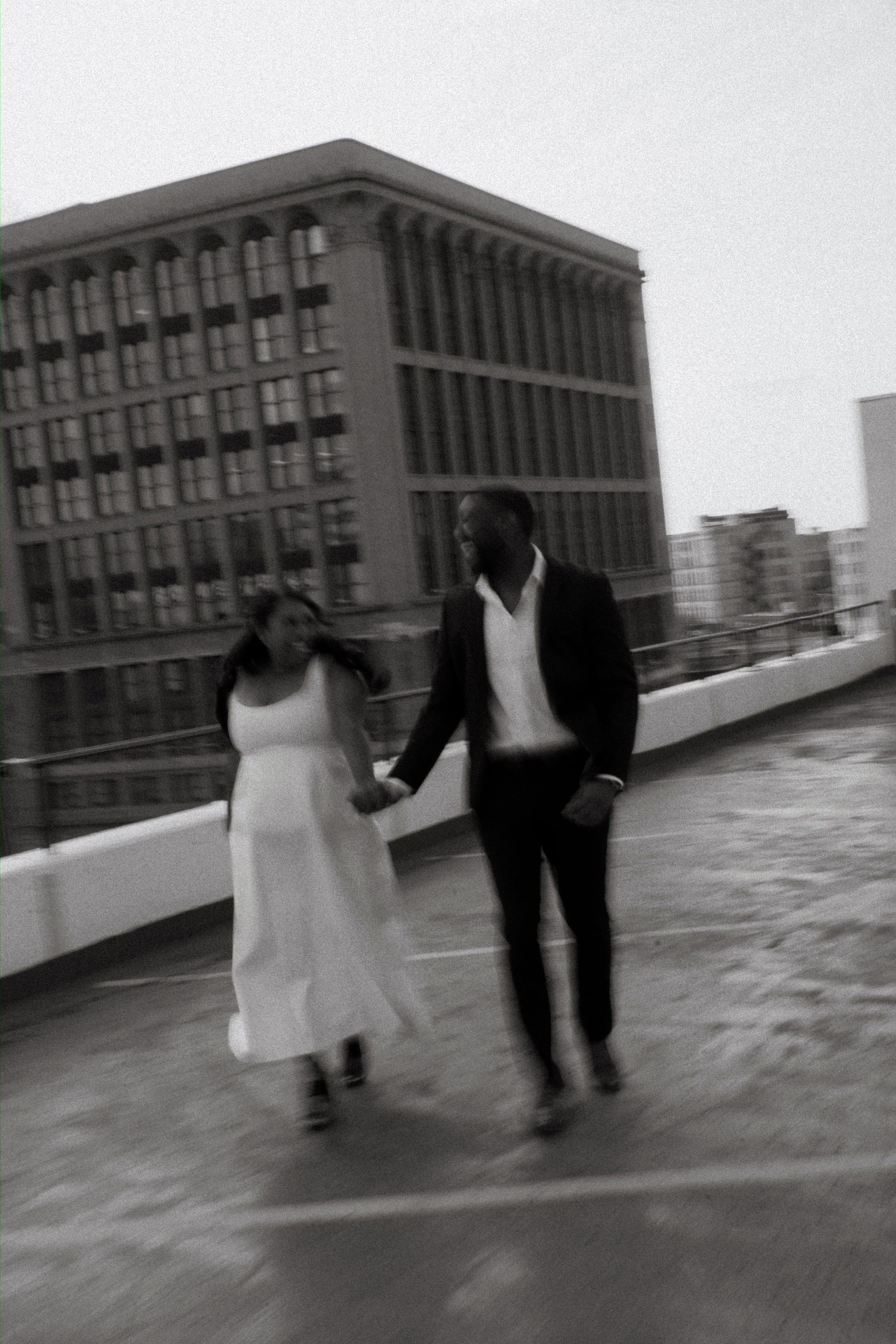 Jaida and Jordan silhouette at sunset on a Winnipeg parkade rooftop — downtown engagement photography by Chris Ngo