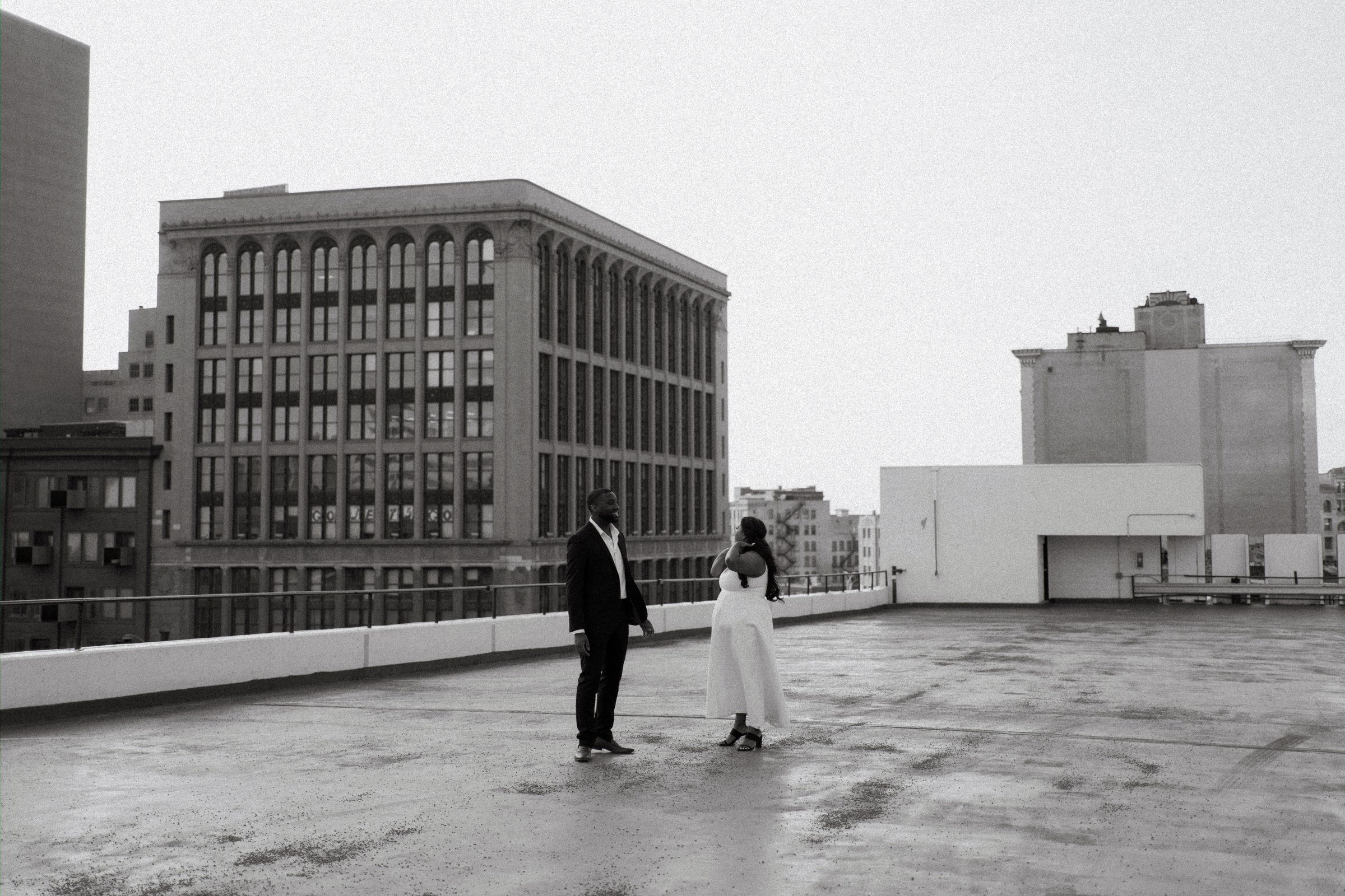 Jaida and Jordan portrait at the end of golden hour on a Winnipeg parkade — engagement photography by Ngo Photography