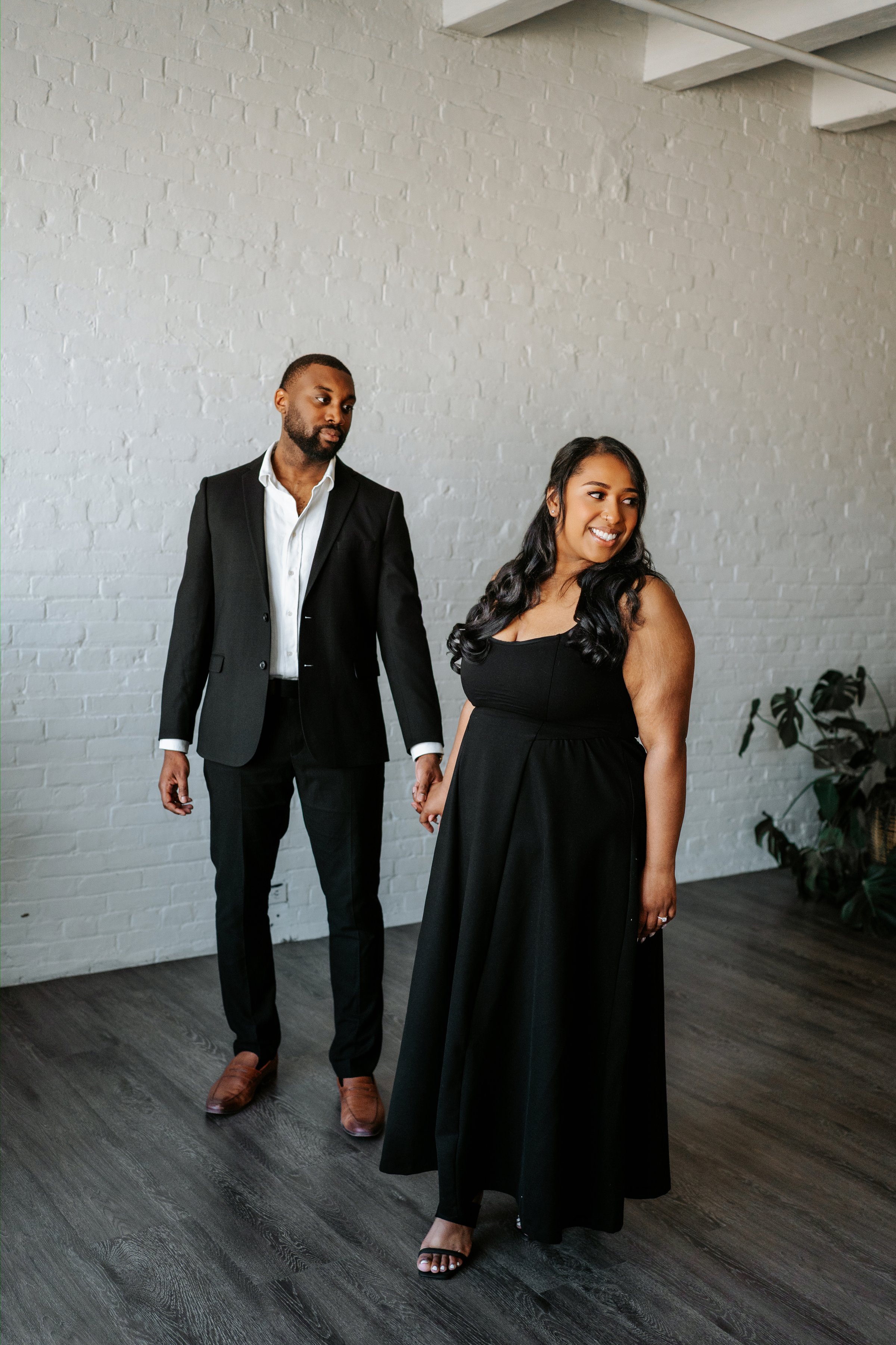 Close portrait of Jaida and Jordan against Exchange District brick in downtown Winnipeg — engagement photography by Chris Ngo
