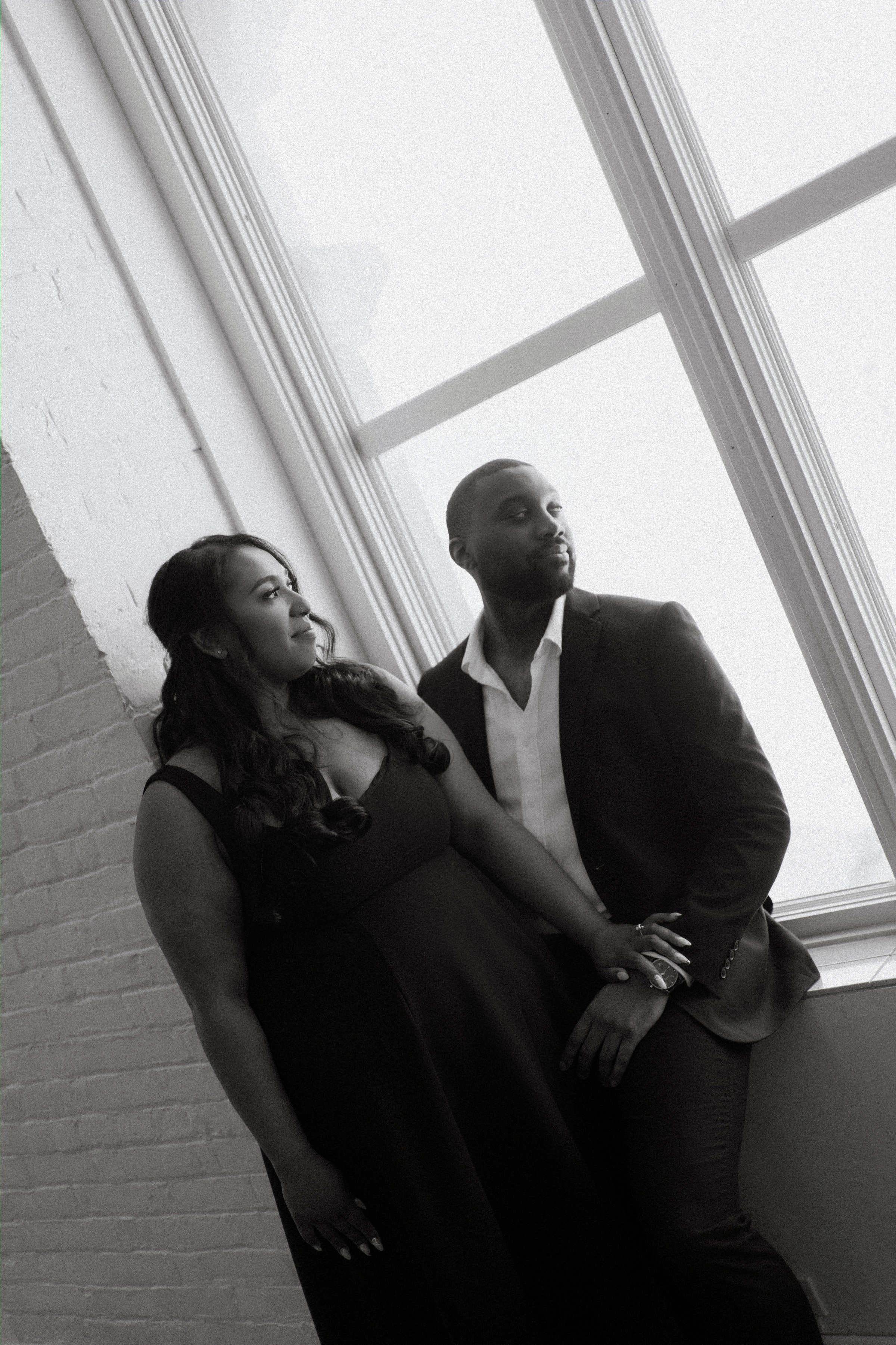 Jaida and Jordan close portrait against textured brick wall in the Exchange District Winnipeg — engagement session by Ngo Photography
