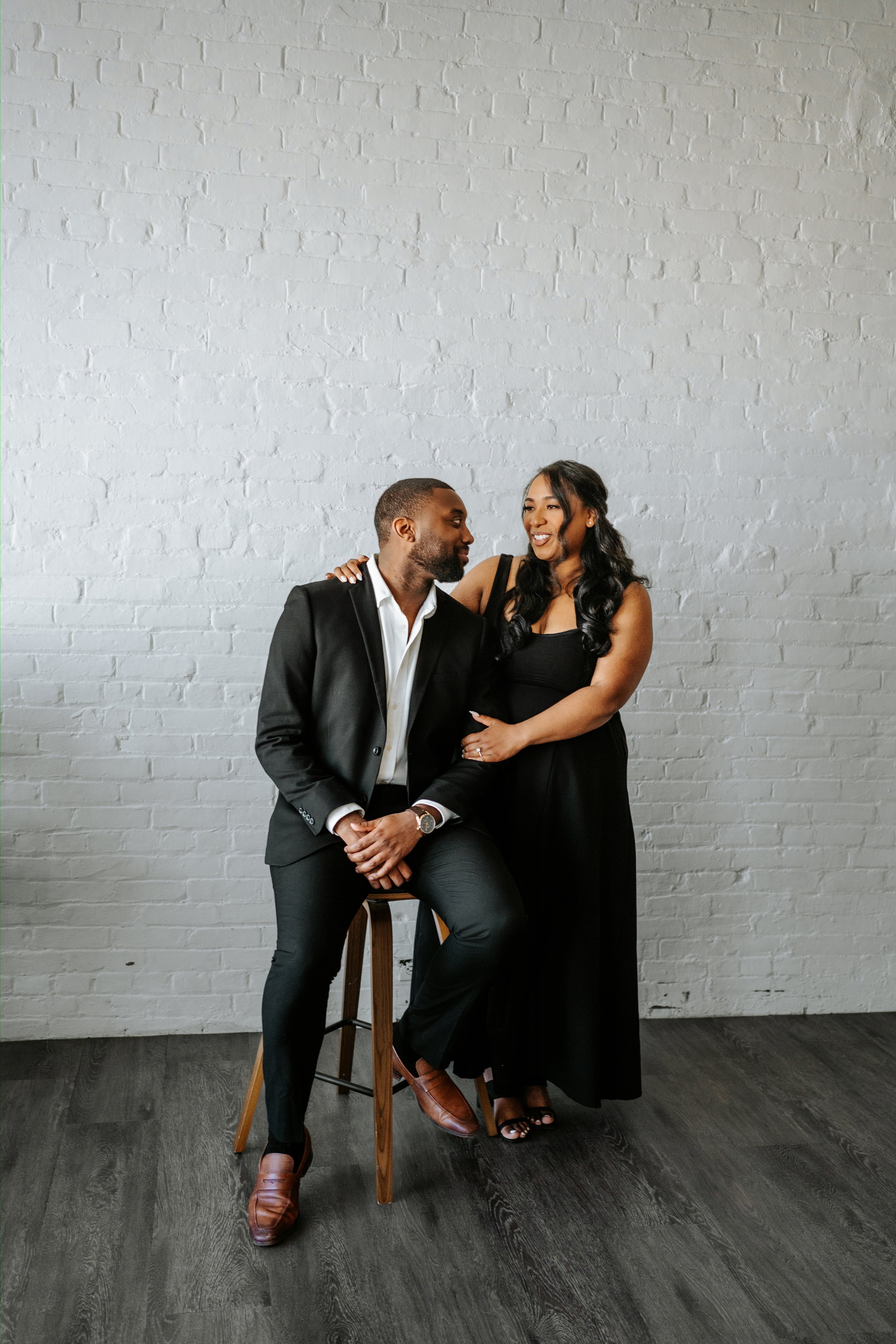 Jordan holding Jaida in the photography studio — engagement session by Chris Ngo downtown Winnipeg
