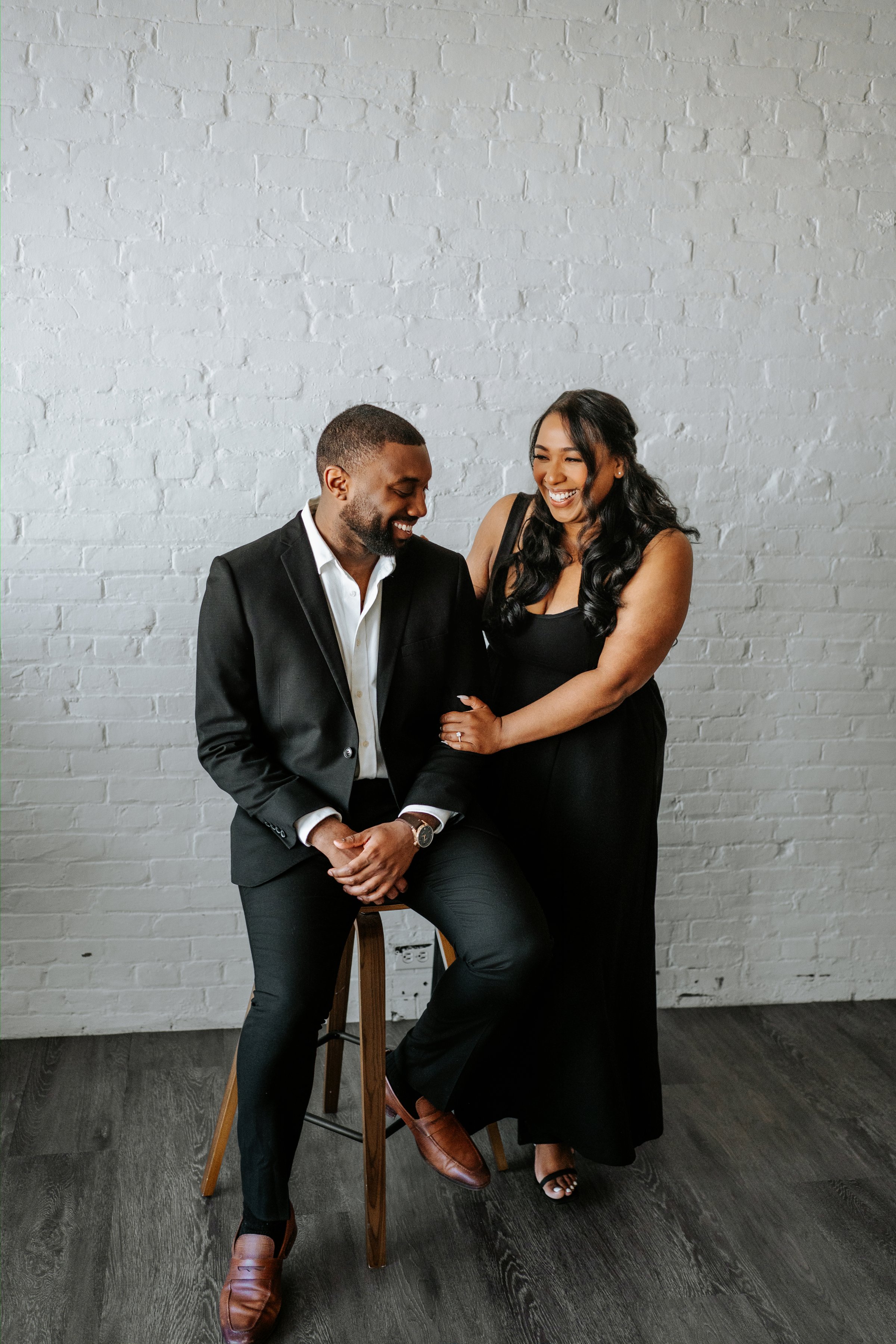 Jaida laughing with Jordan in the photography studio — engagement session by Chris Ngo Winnipeg