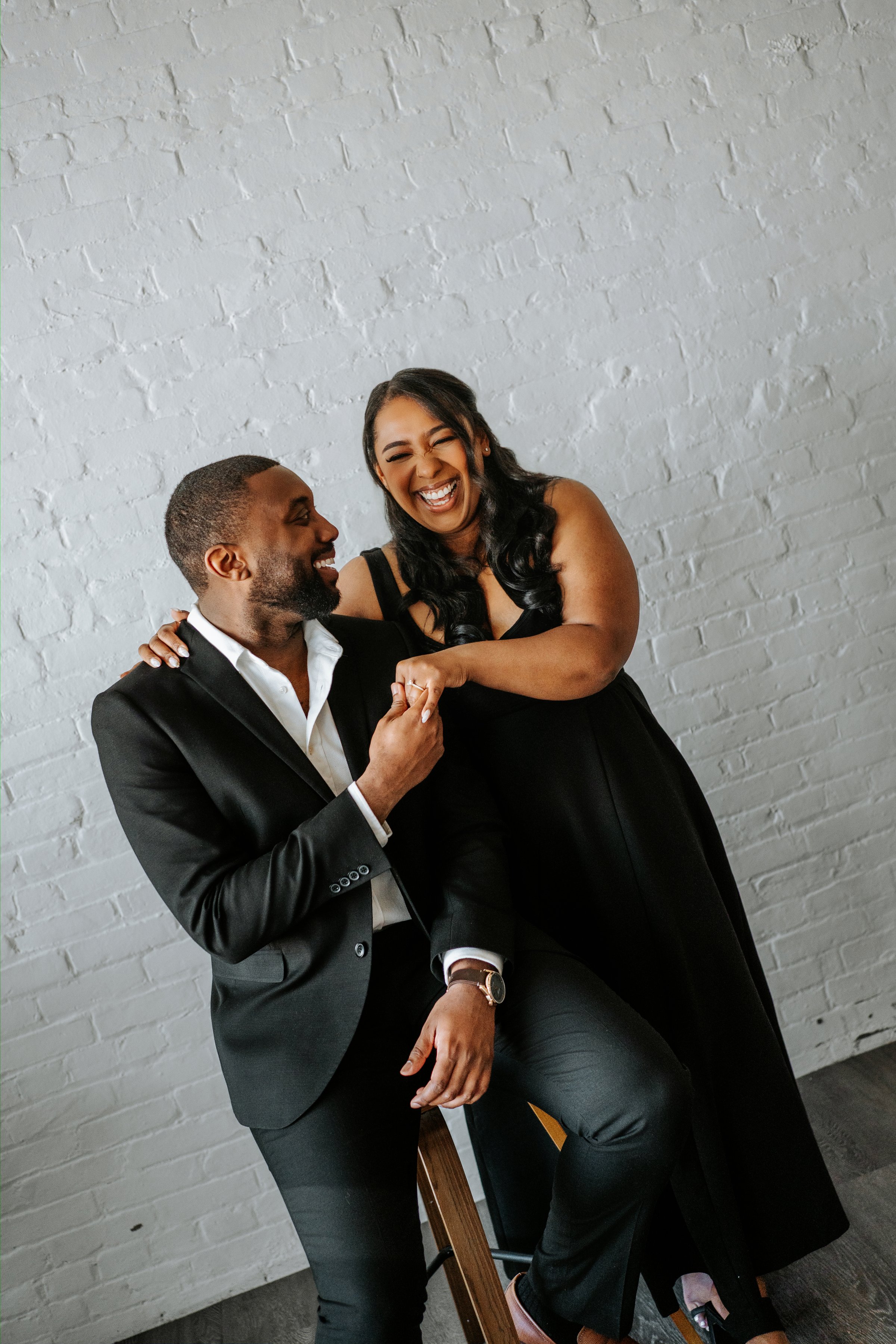 Jordan holding Jaida's hand in the photography studio — engagement session Winnipeg by Chris Ngo