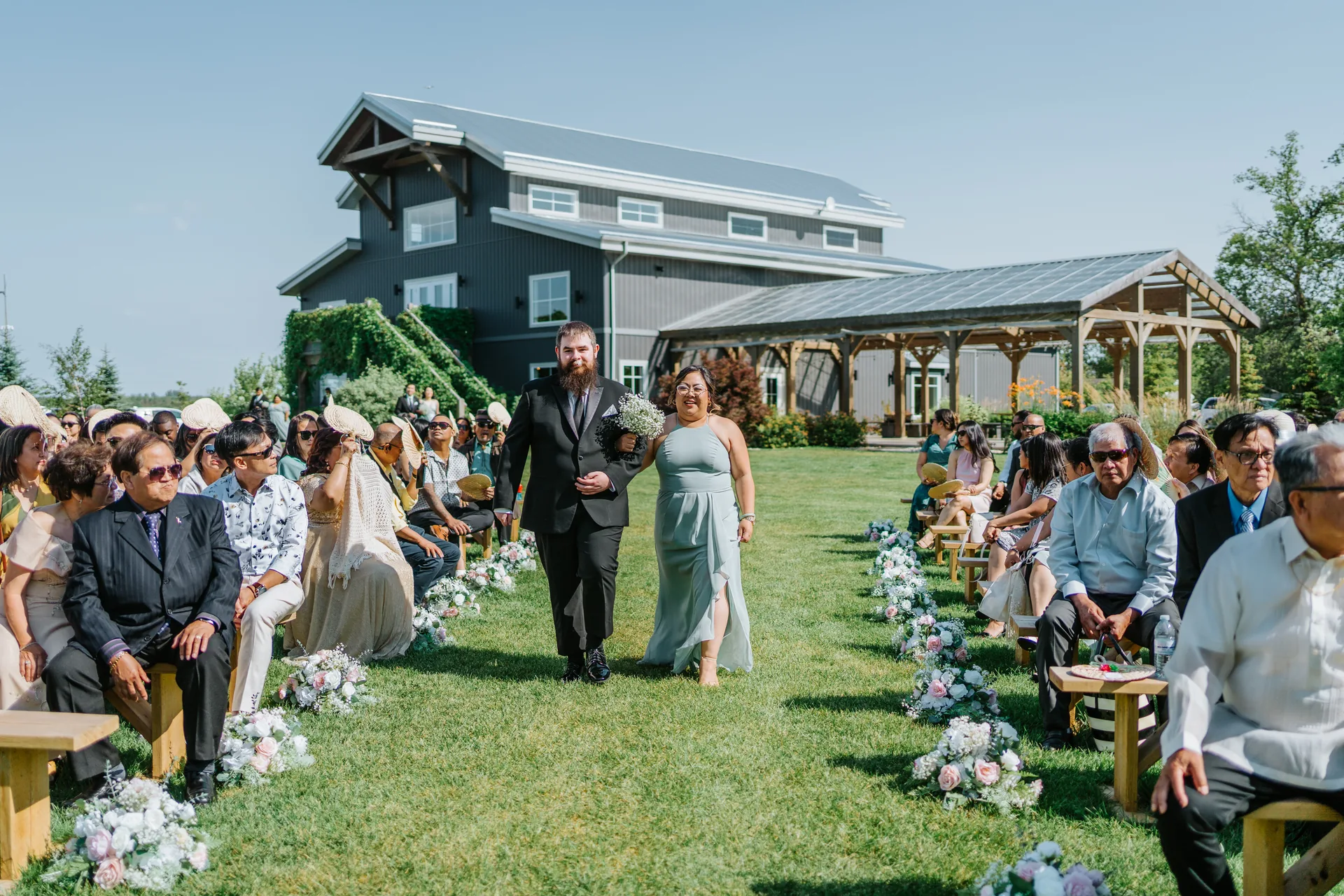 Bridesmaid walking the processional at Hawthorne Estates outdoor ceremony, Manitoba