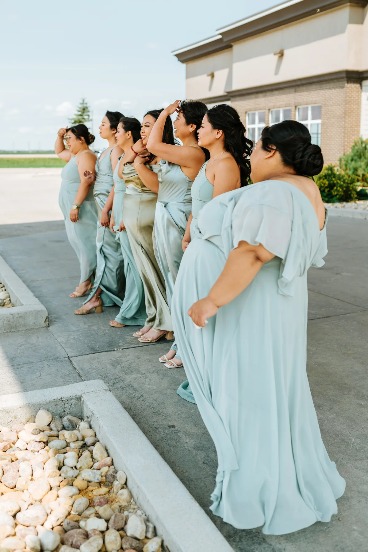 Bridesmaid in sage green dress laughing — Hawthorne Estates wedding, Manitoba