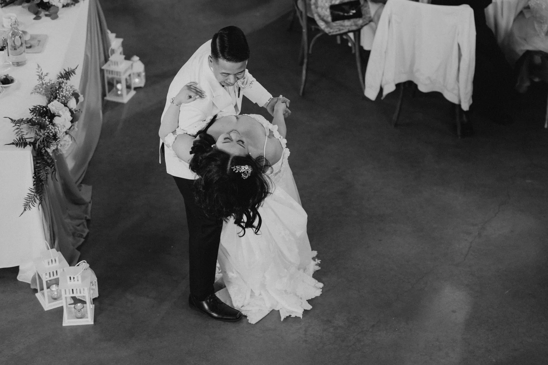 Aerial black and white first dance dip — Jay and Mark at Hawthorne Estates reception, Manitoba