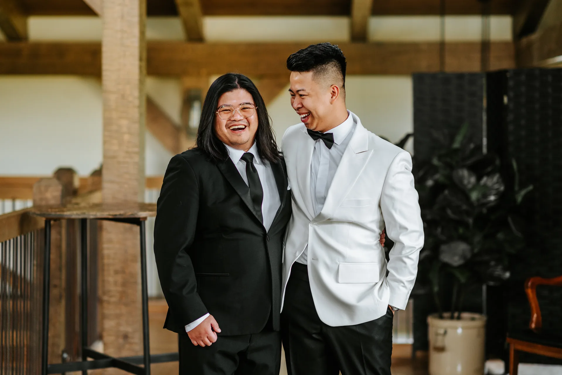 Mark and best man laughing inside the Hawthorne Estates barn — Manitoba wedding