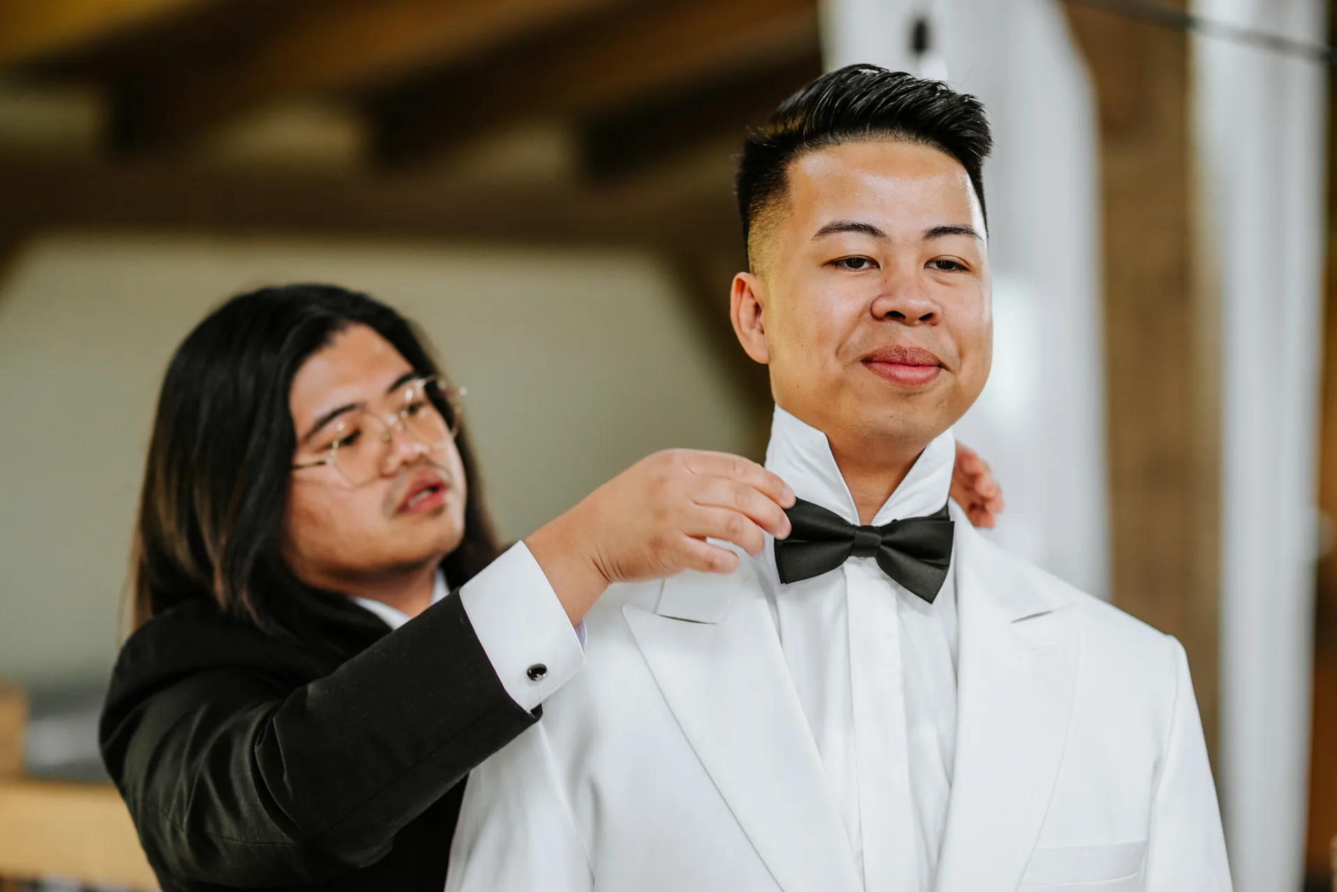 Best man adjusting Mark's bow tie getting ready at Hawthorne Estates, Manitoba