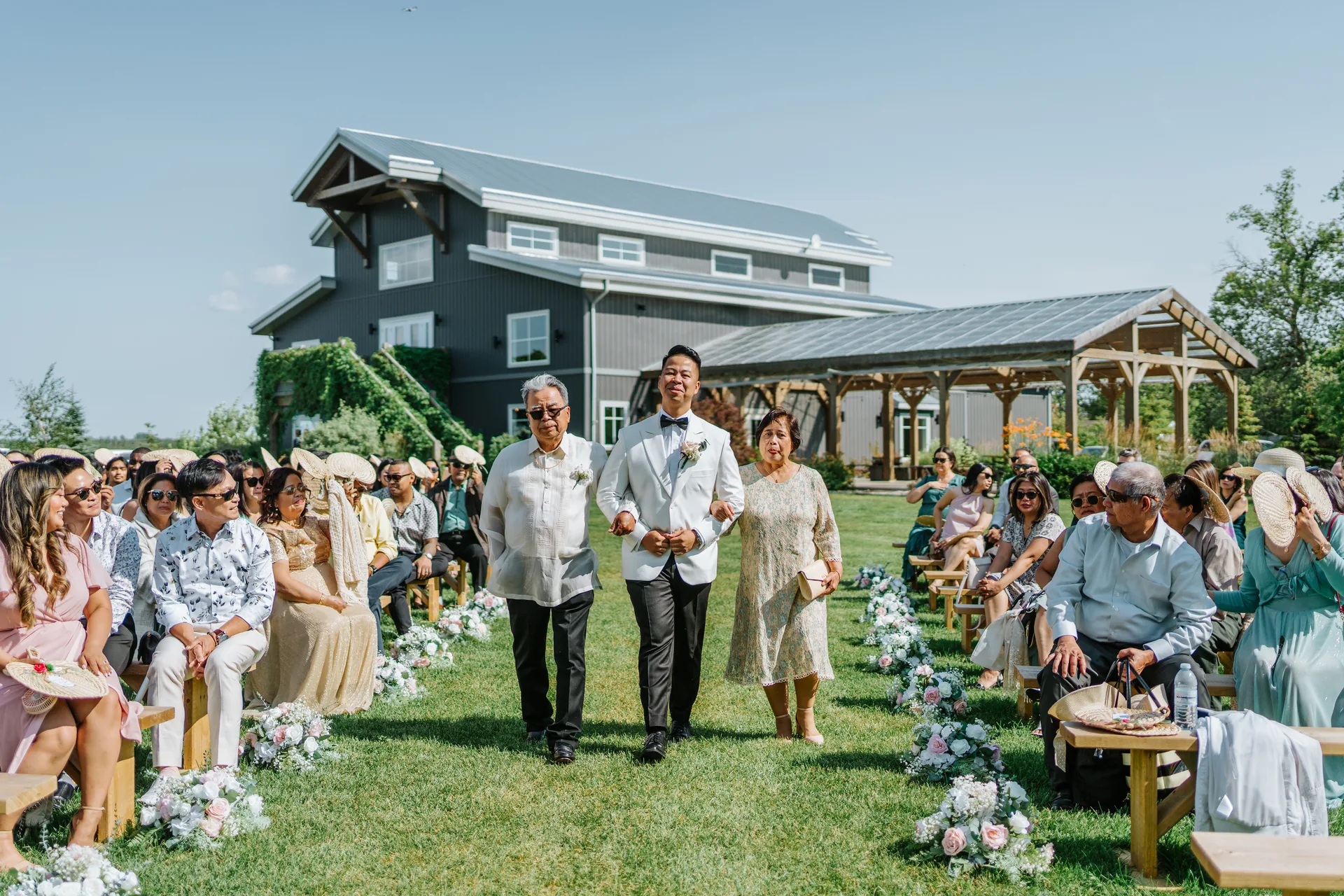 Mark walking the processional aisle with his parents at Hawthorne Estates, Manitoba