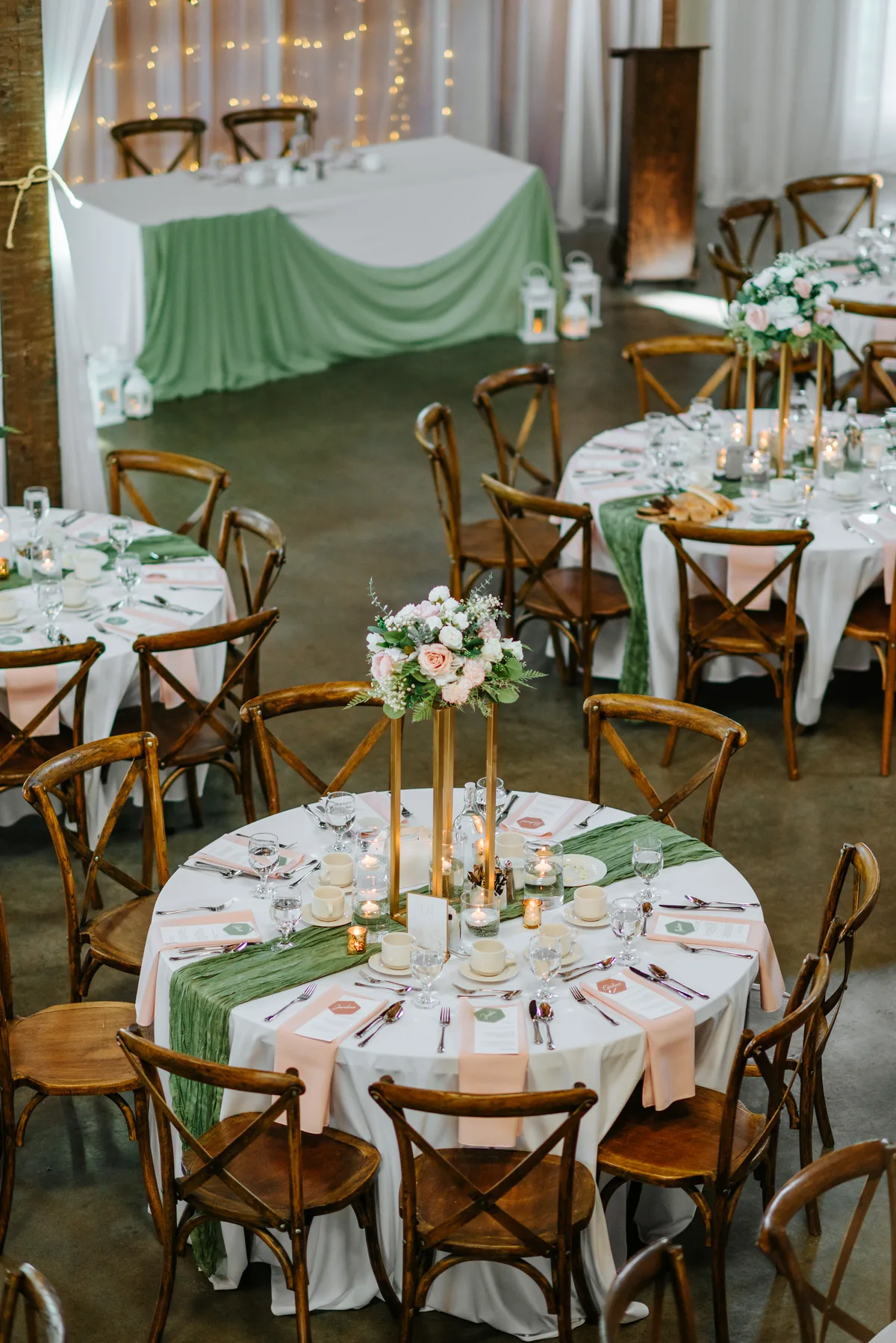 Hawthorne Estates reception barn room setup with crossback chairs and green table runners, Manitoba