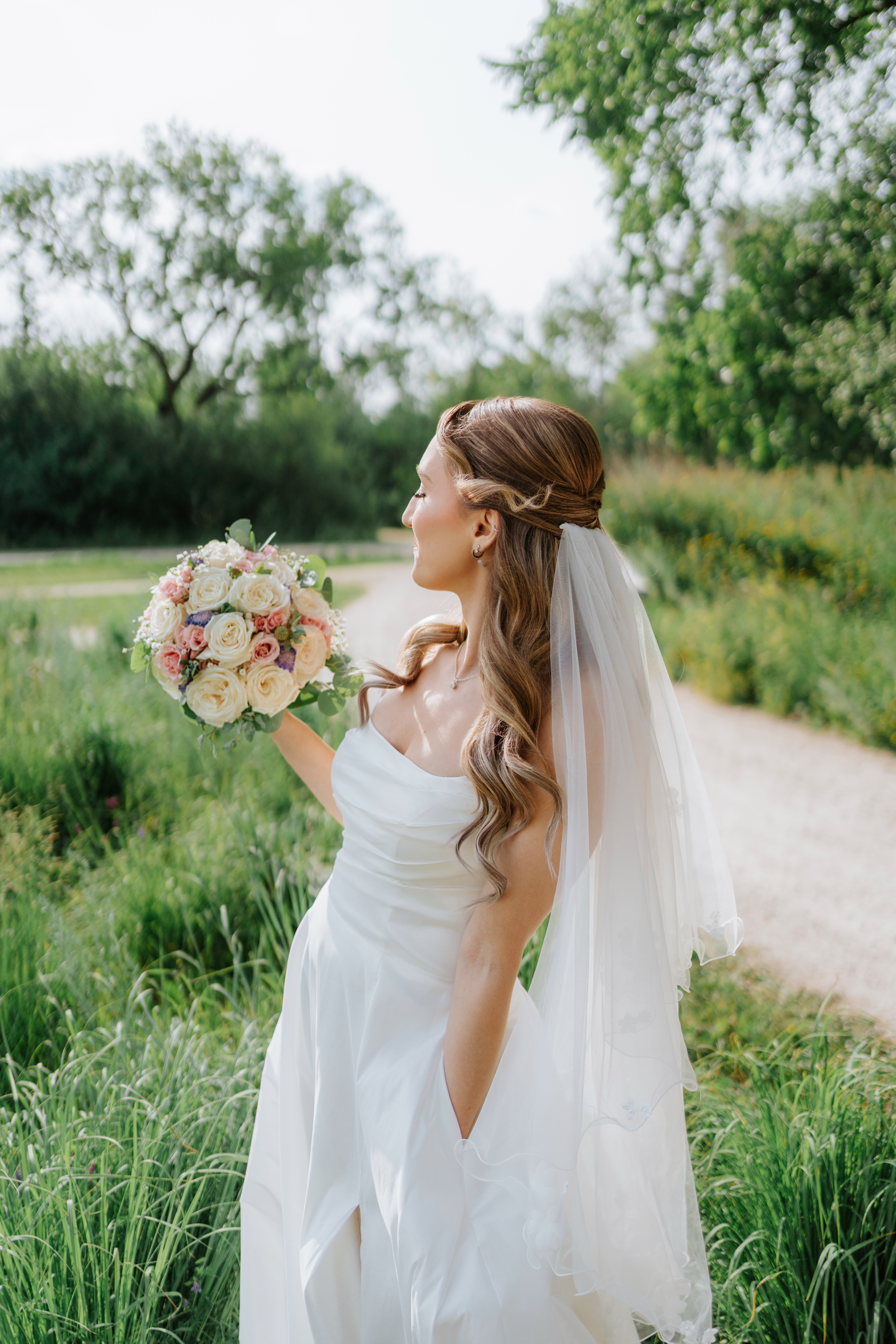 Tanya bride profile portrait with veil and pink and white bouquet at Assiniboine Park — wedding photography by Chris Ngo Winnipeg