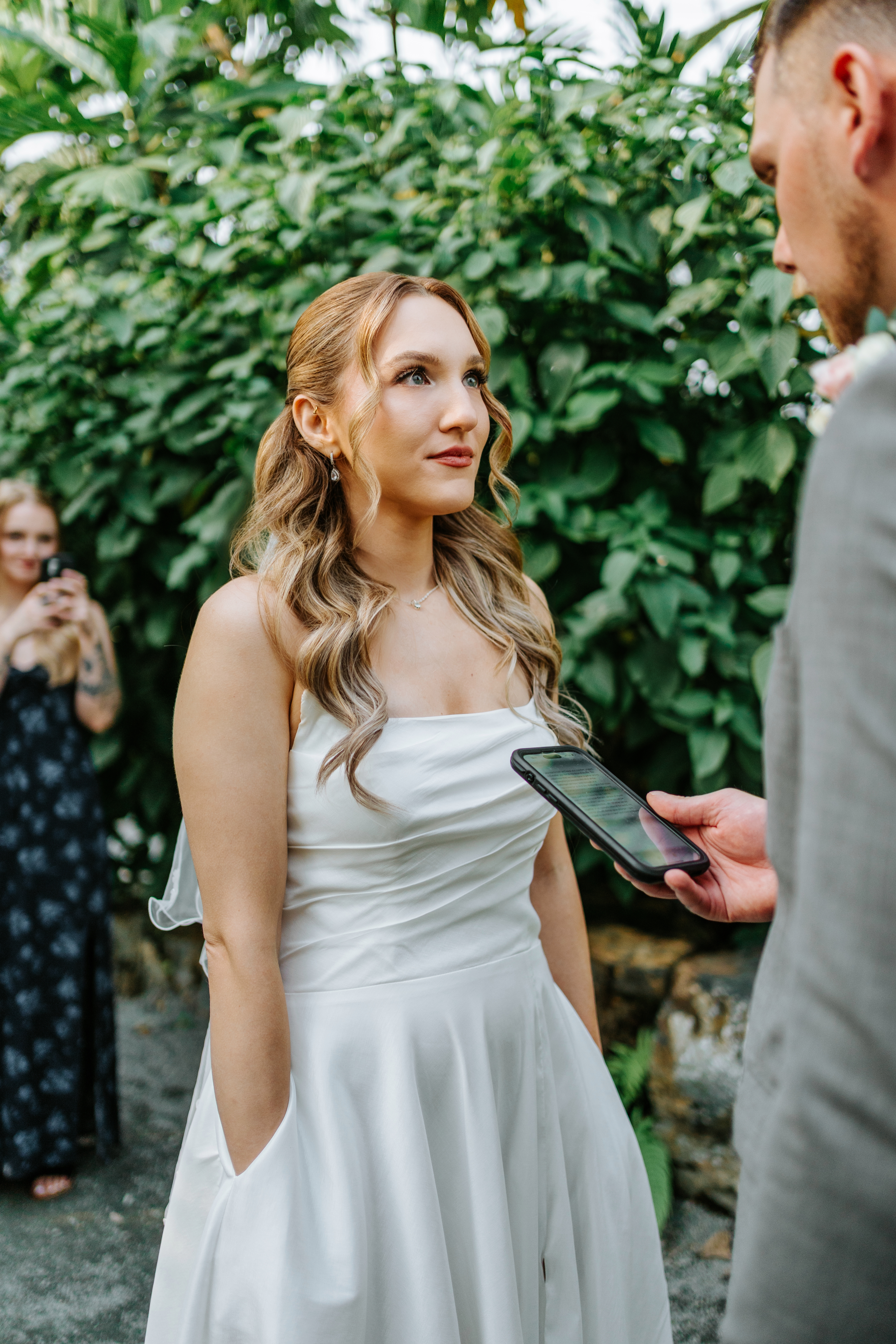 Tanya reading personal vows from her phone during the intimate ceremony inside The Leaf botanical garden Winnipeg — Ngo Photography