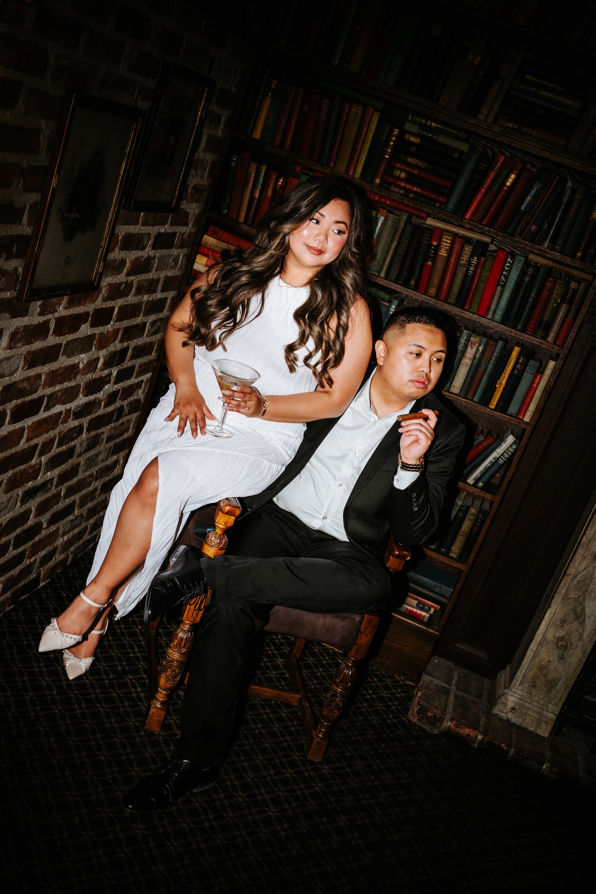 Editorial engagement couple in dark library — Winnipeg engagement photographer
