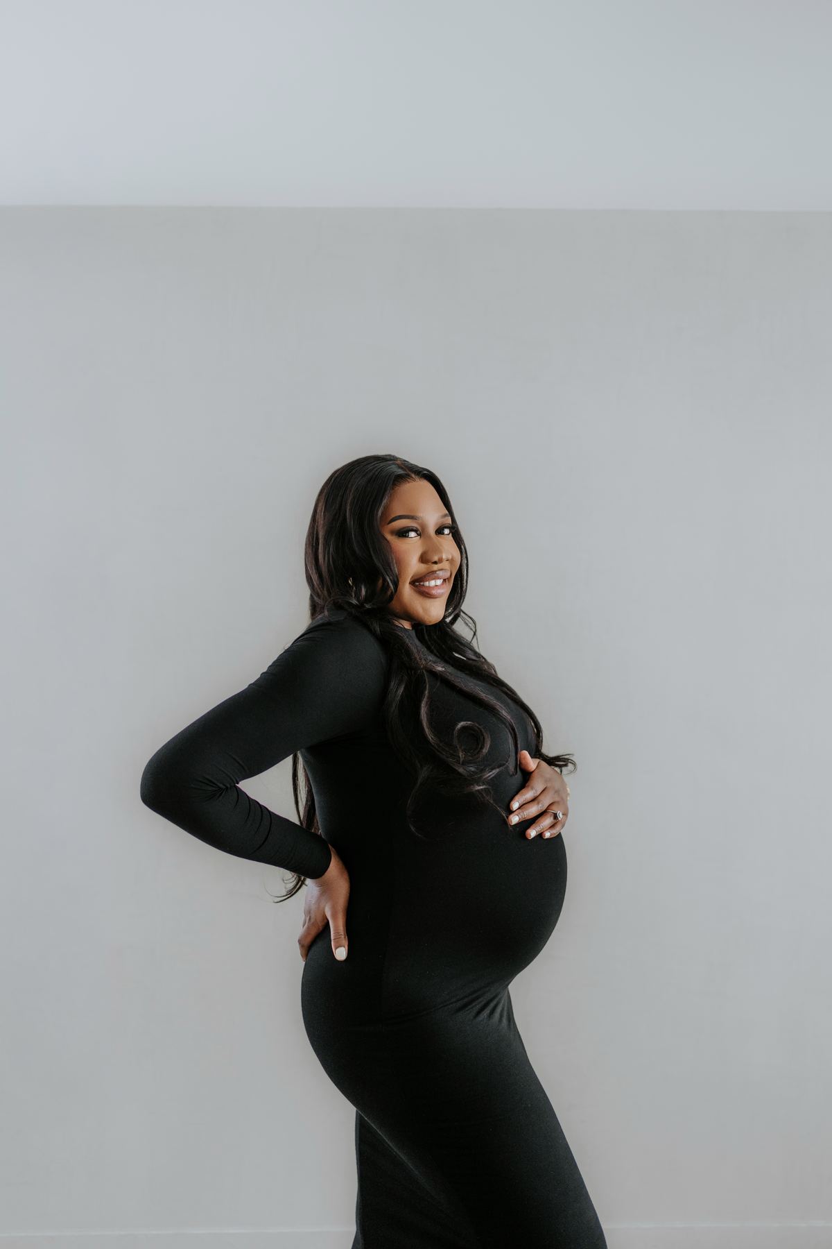 Maternity portrait with flowing hair and dramatic pose — Winnipeg studio photography by Ngo Photography