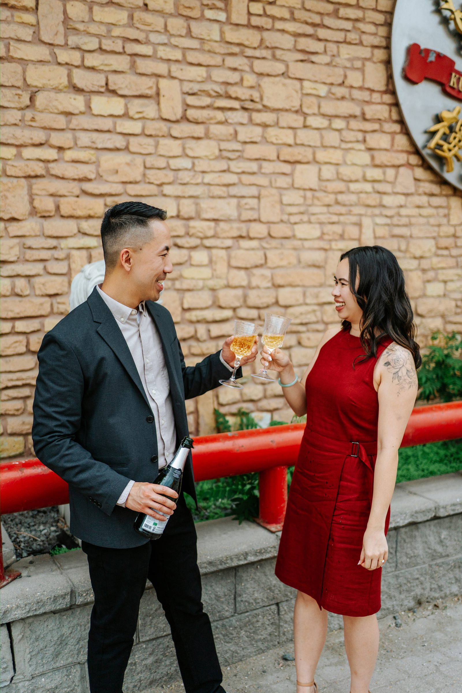 Monica and Jason candid celebration outside Kum Koon Garden in Winnipeg — Chinese heritage engagement photography by Chris Ngo