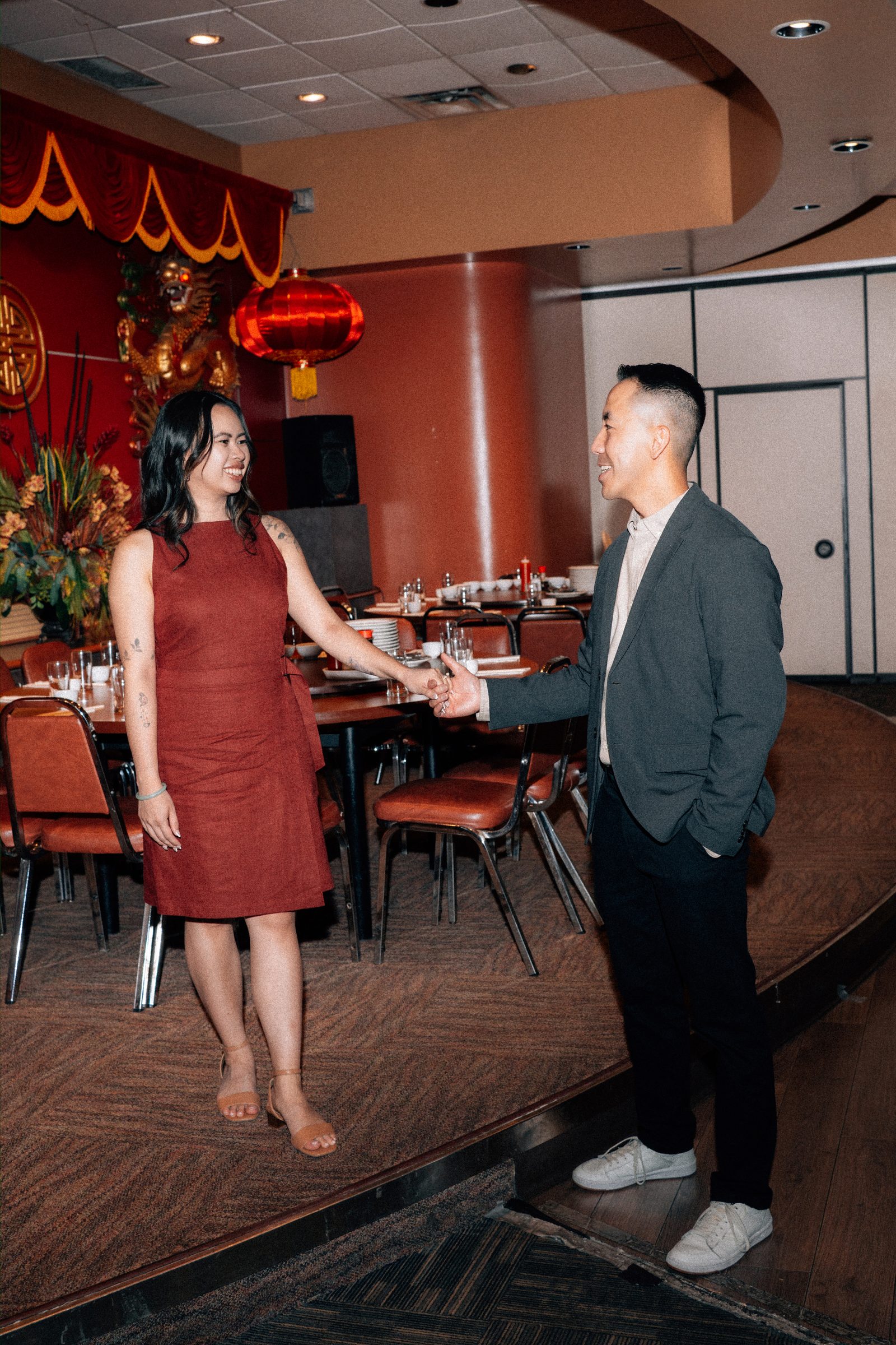 Monica and Jason candid moment at Kum Koon Garden Winnipeg restaurant — engagement photography by Ngo Photography