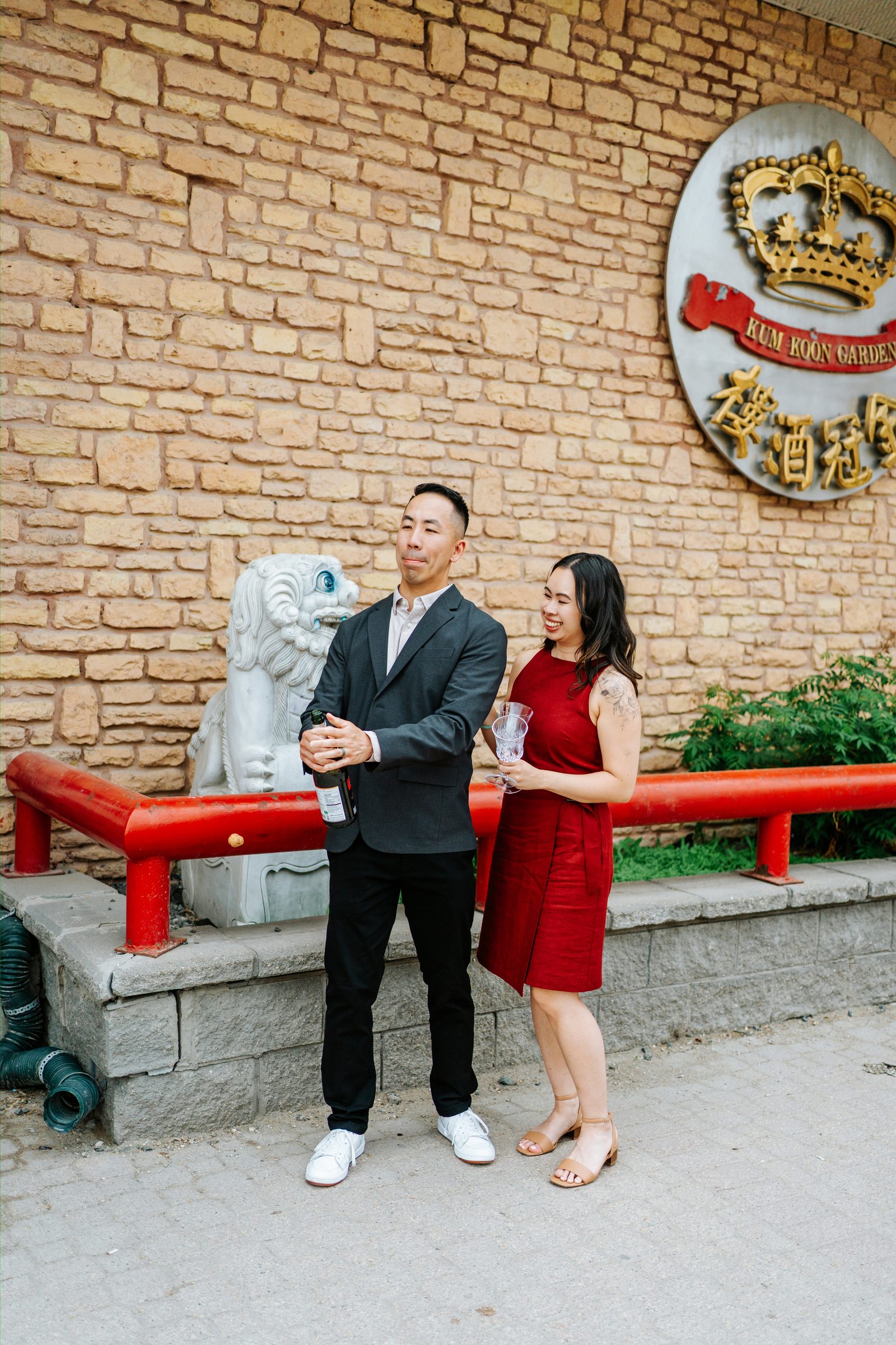Monica and Jason seated at the round banquet table at Kum Koon Garden Winnipeg — Chinese heritage engagement photography by Chris Ngo