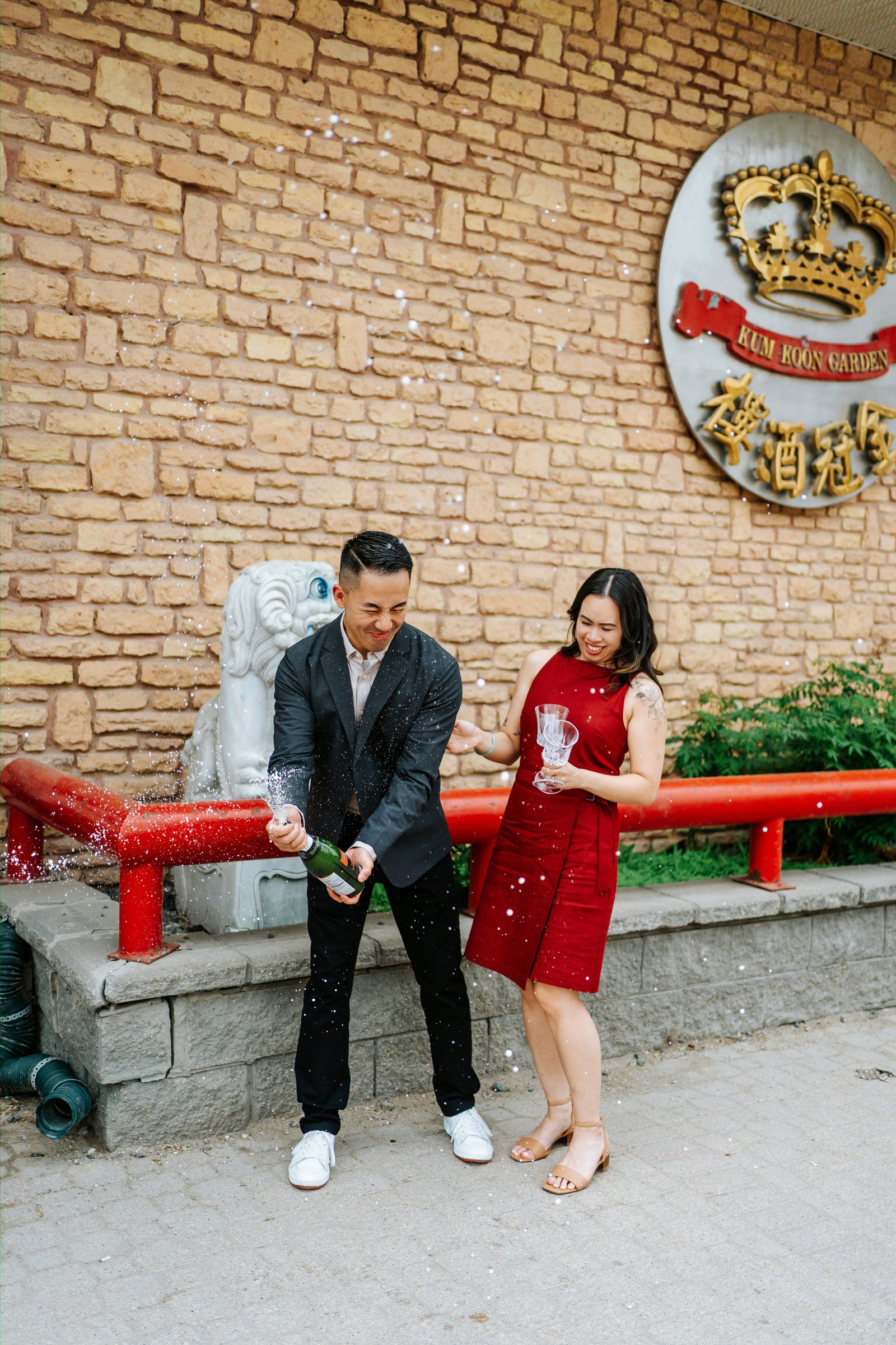 Monica and Jason in the warm amber light of Kum Koon Garden restaurant — Winnipeg Chinese restaurant engagement photography by Ngo Photography