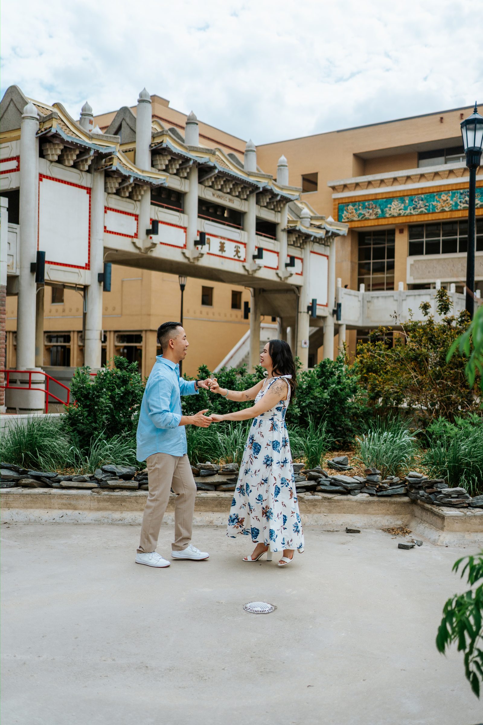 Monica and Jason in front of Winnipeg's iconic Chinatown ceremonial gate — Chinese and Vietnamese heritage engagement photography by Chris Ngo, Ngo Photography