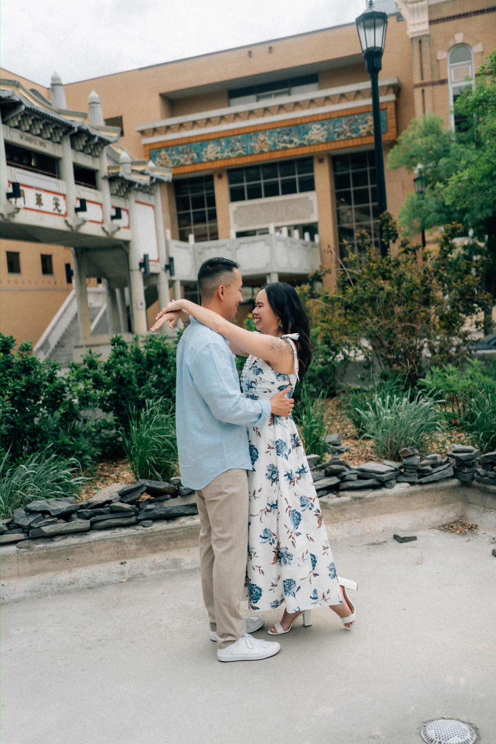 Monica and Jason close portrait against Chinatown architecture in Winnipeg — Chinese engagement photography by Ngo Photography