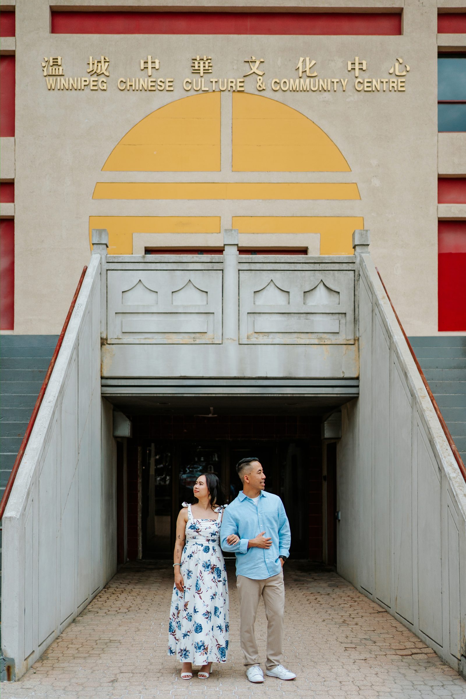 Monica and Jason candid on a Chinatown street in Winnipeg — Vietnamese Chinese engagement session by Chris Ngo