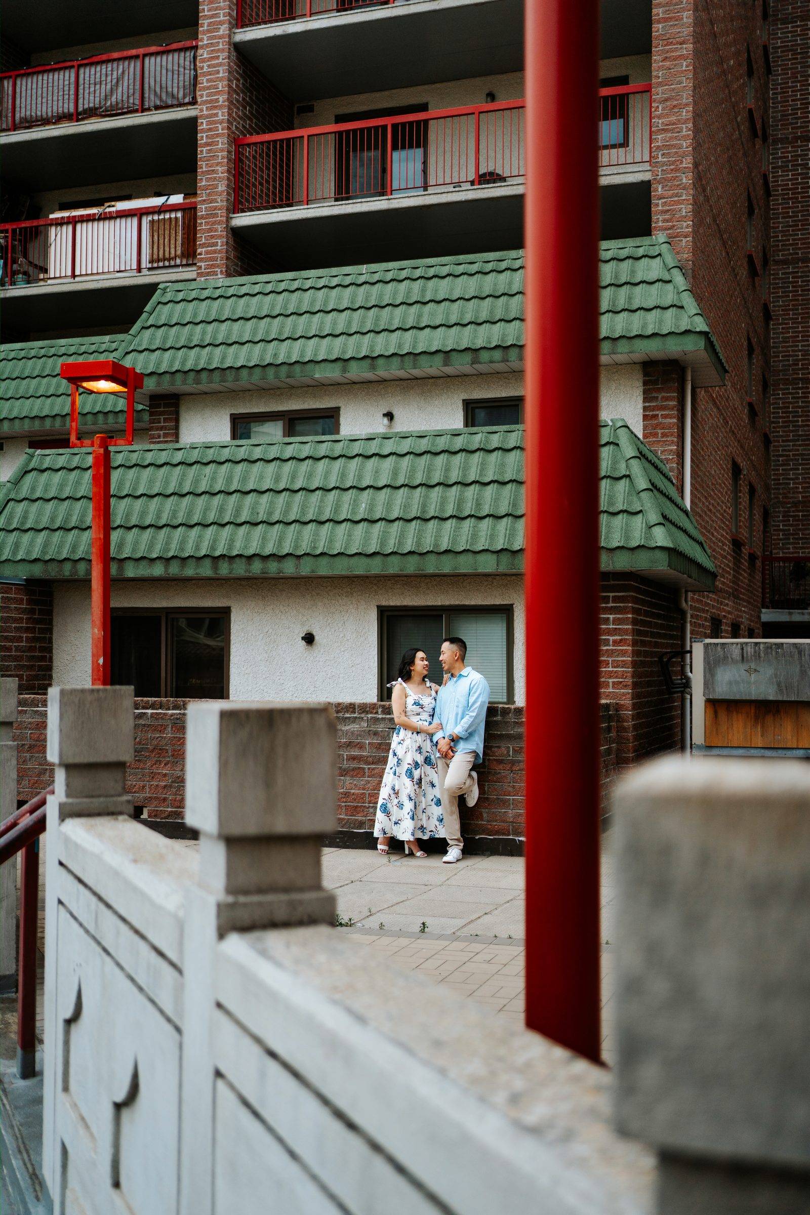 Monica and Jason laughing together in Winnipeg Chinatown — culturally inspired engagement photography by Chris Ngo