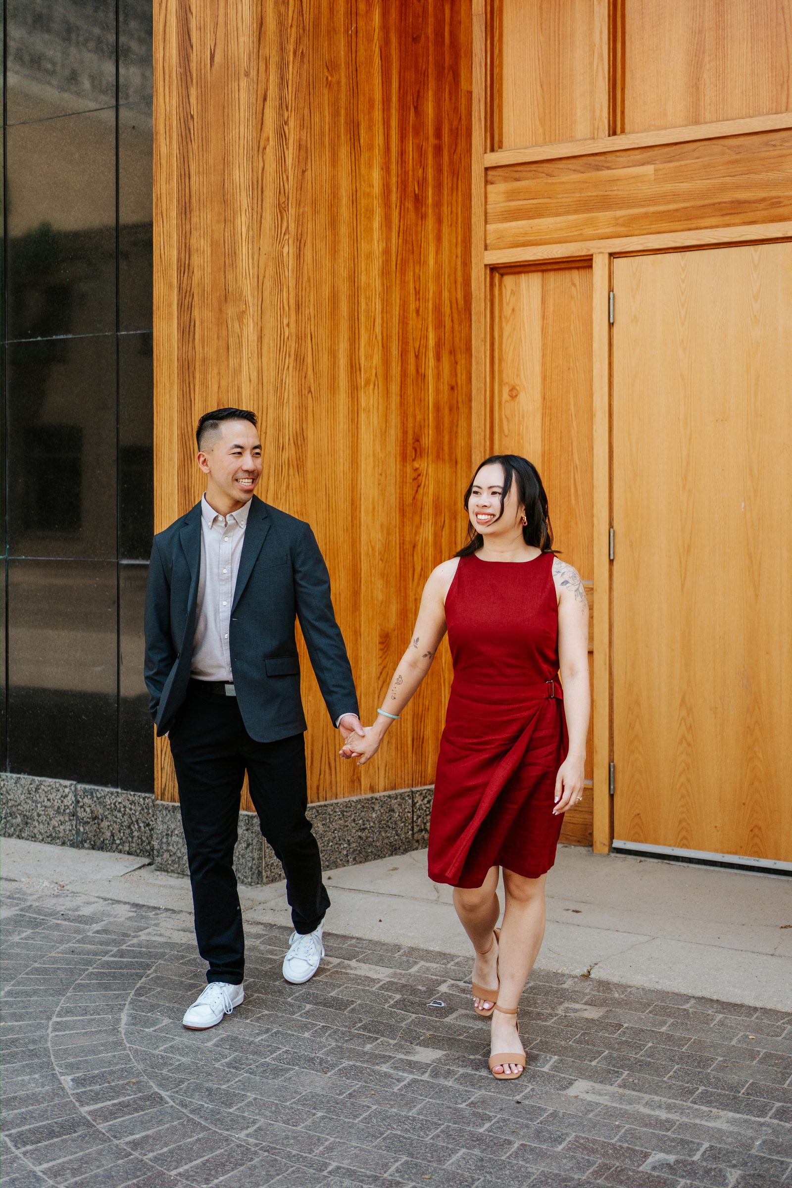 Monica and Jason final studio portrait in red dress and dark blazer — Winnipeg engagement photography by Ngo Photography
