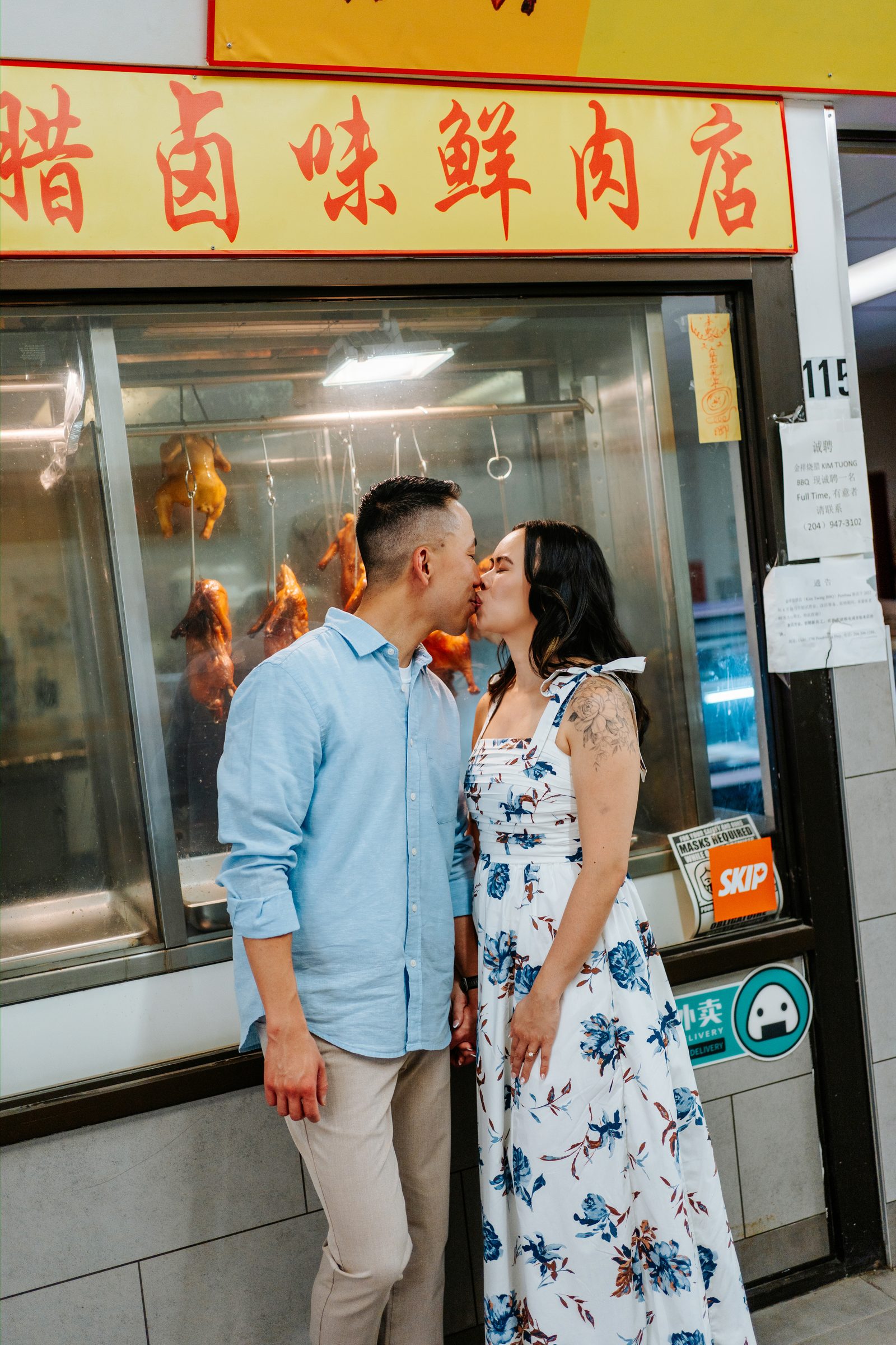 Monica and Jason entering Sun-Wah Centre grocery market in Winnipeg Chinatown — Chinese Vietnamese engagement photography by Chris Ngo
