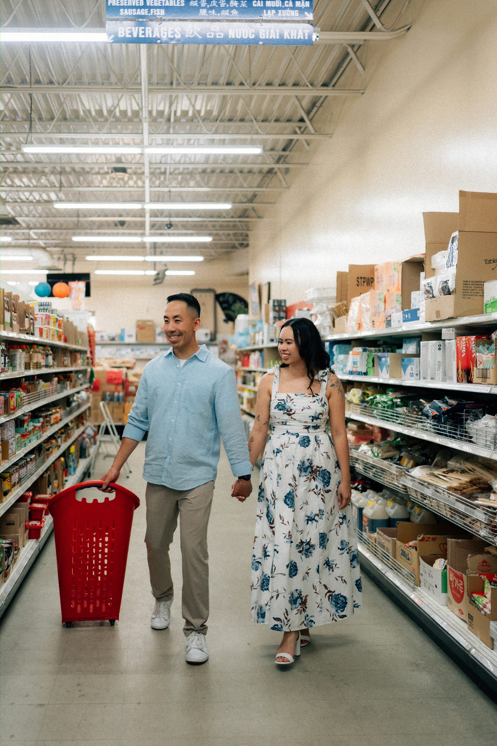 Jason and Monica candid moment inside Sun-Wah grocery market Chinatown Winnipeg — Chinese Vietnamese engagement photography by Chris Ngo