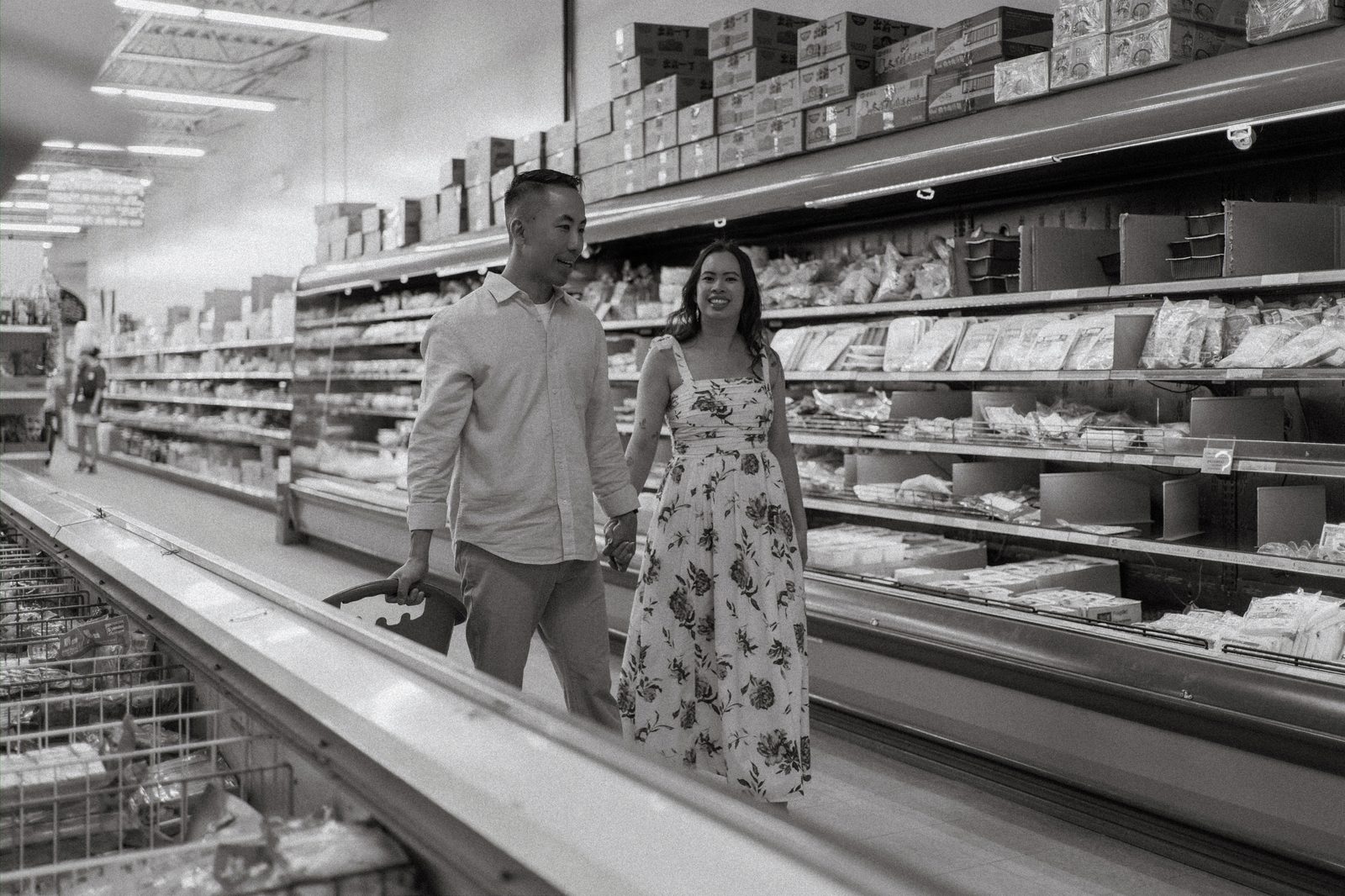 Monica and Jason in the dry goods aisle at Sun-Wah Centre Winnipeg — culturally inspired engagement photography by Ngo Photography