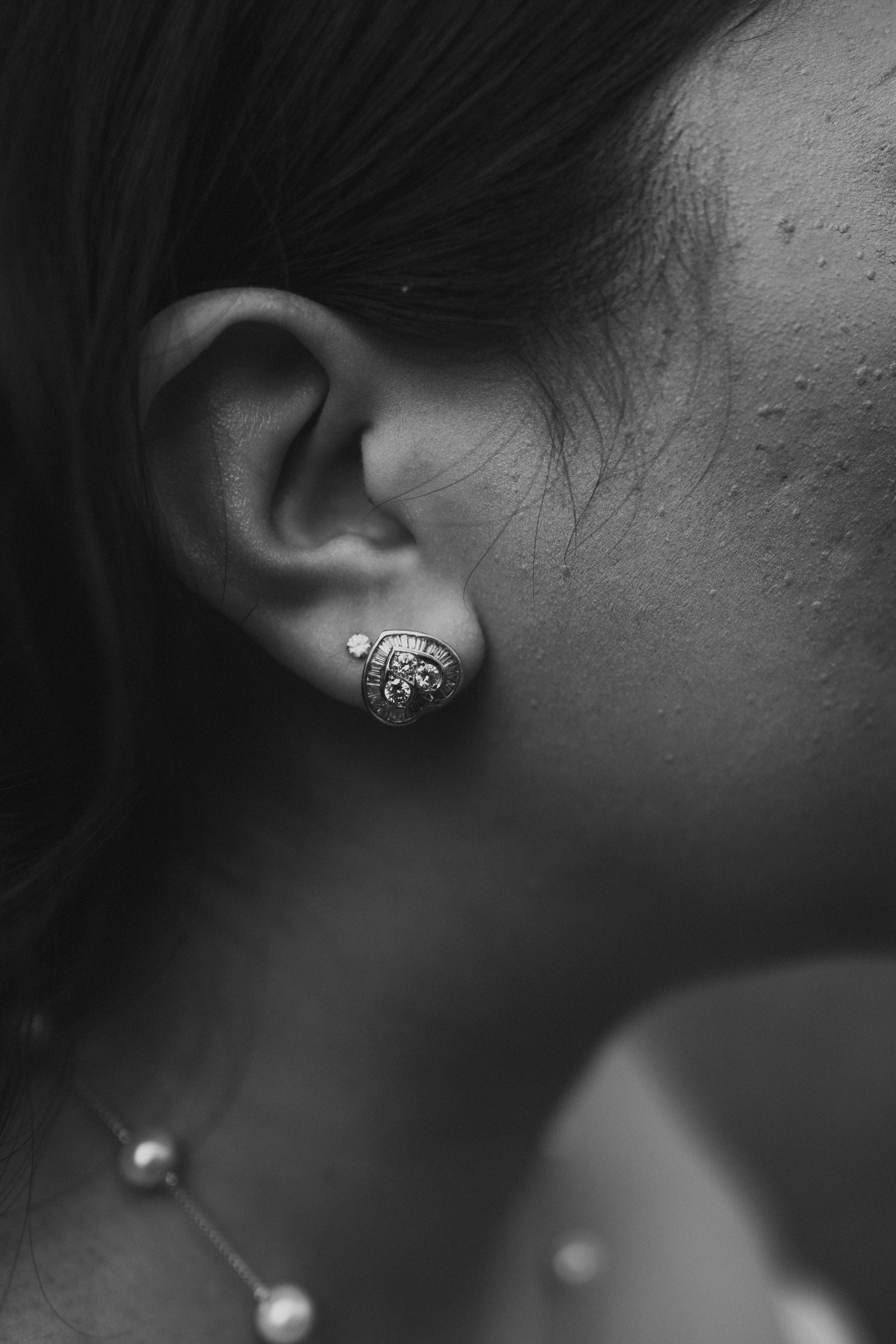 Close-up black and white detail of Ayanna's vintage diamond cluster earring on her wedding morning — Ngo Photography Winnipeg