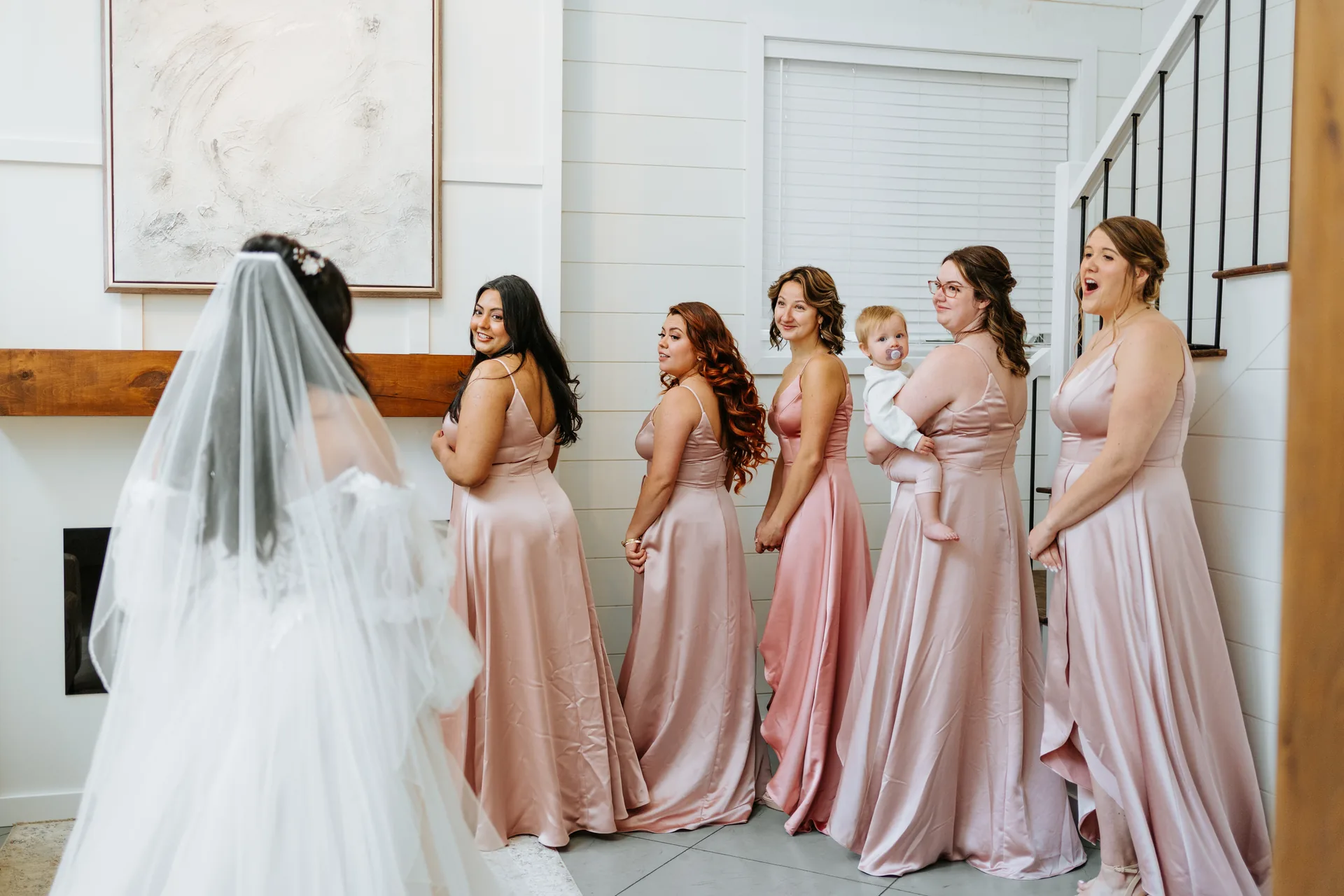 Bridal party getting ready together in the farmhouse at Oakland Estates Manitoba — blush bridesmaids dresses