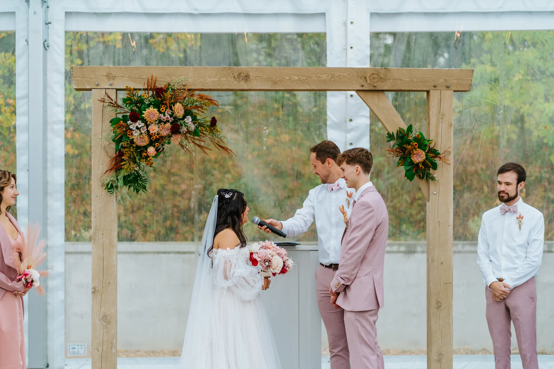 Paola and Riley signing the marriage register at the wooden table — Oakland Estates Manitoba wedding photography