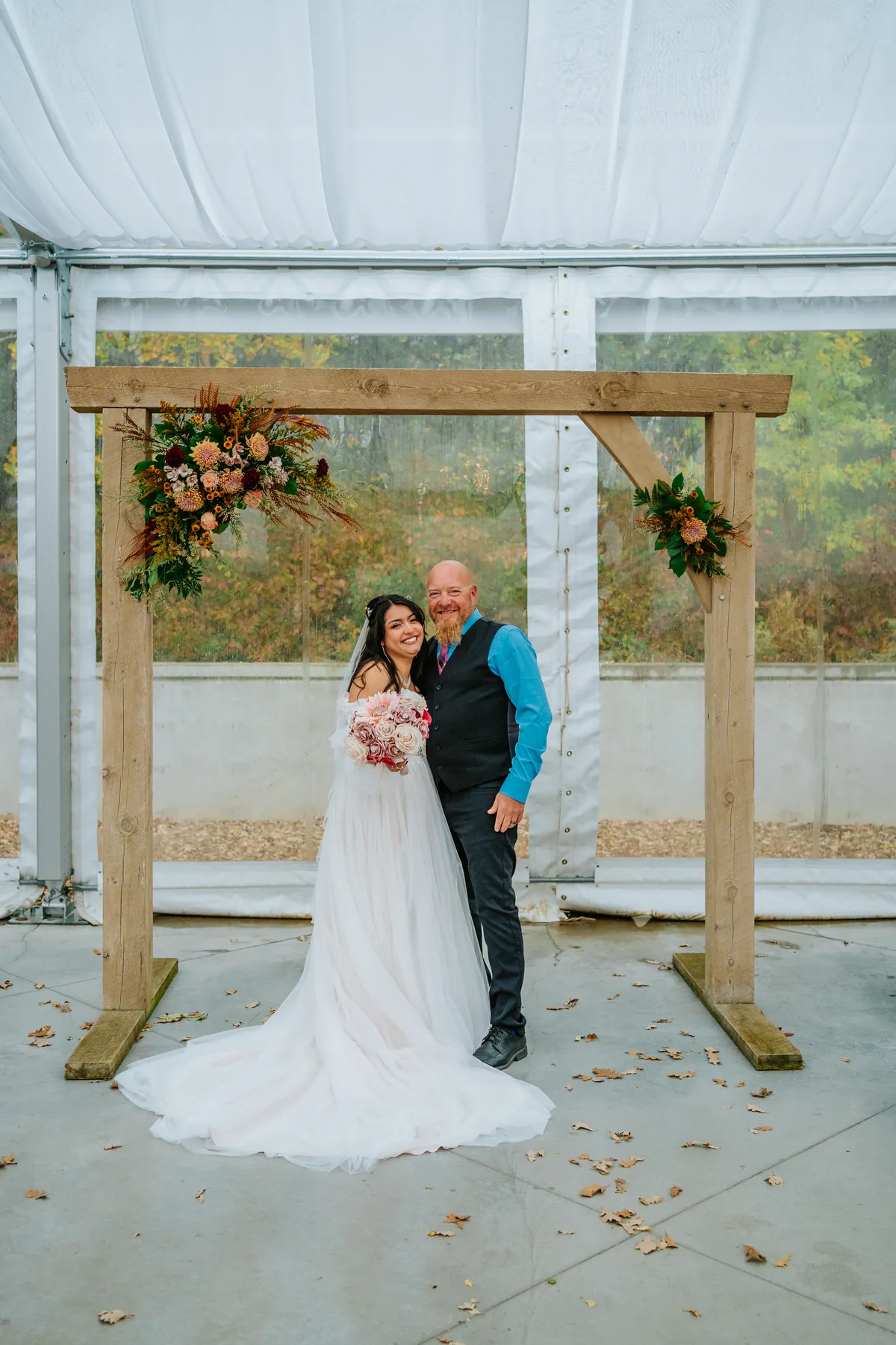 Paola and Riley kissing in fall foliage at Oakland Estates Manitoba — wedding photography by Chris Ngo