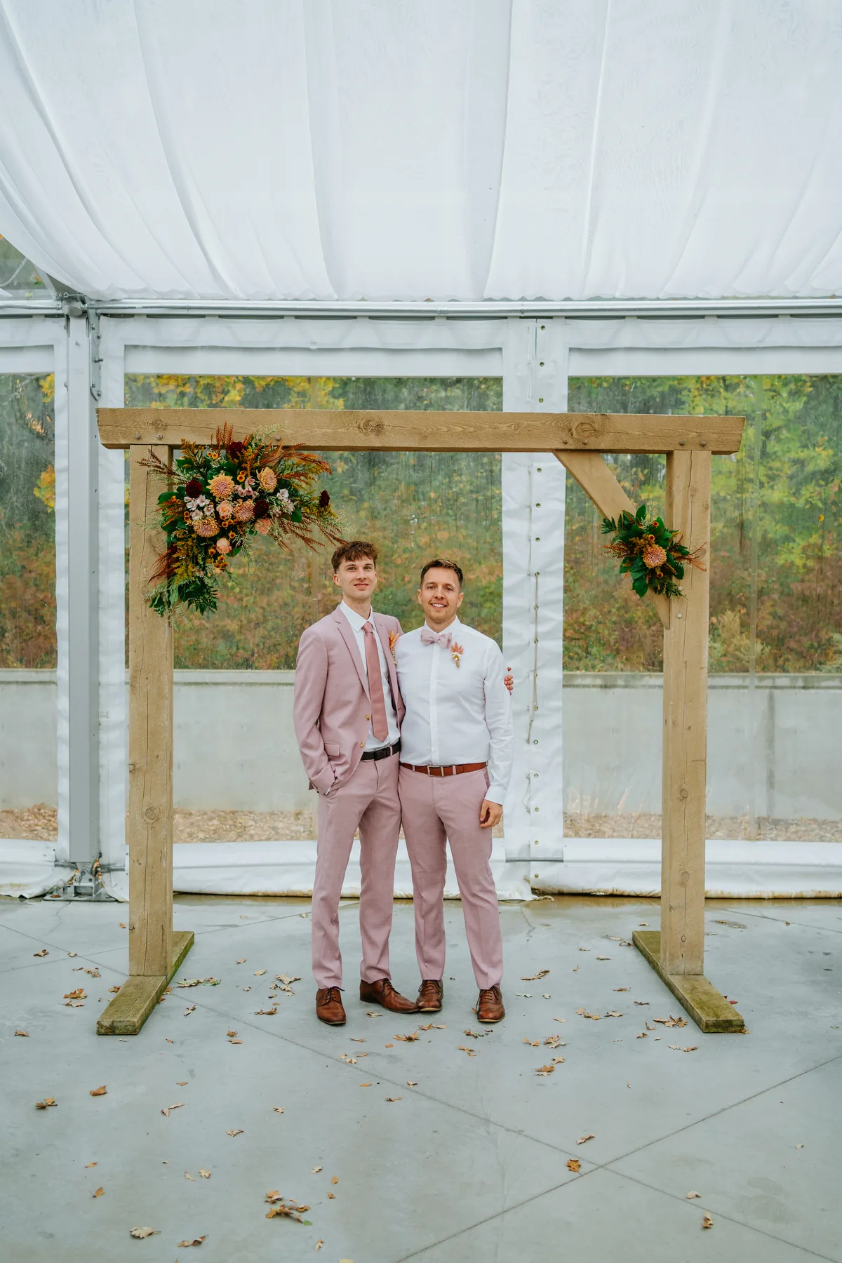Paola and Riley walking together in fall leaves at Oakland Estates Manitoba wedding photography by Chris Ngo