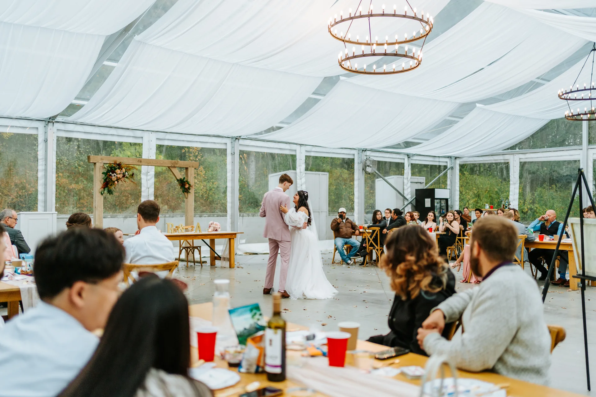 First dance couple portrait with string lights in the glass tent at Oakland Estates Manitoba wedding