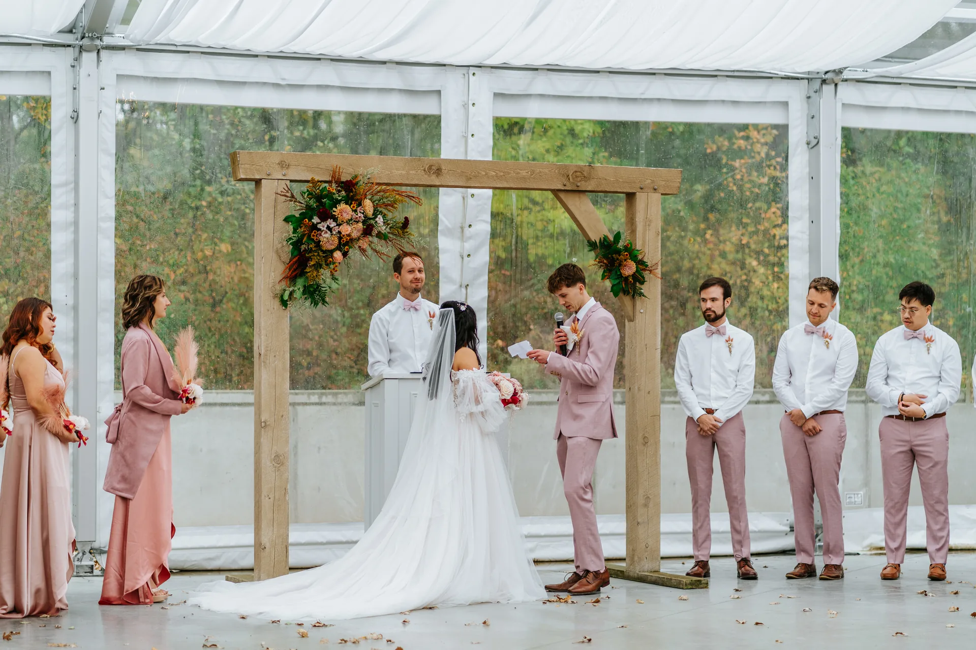 First kiss with confetti falling inside the glass marquee tent at Oakland Estates Manitoba — wedding photography by Chris Ngo