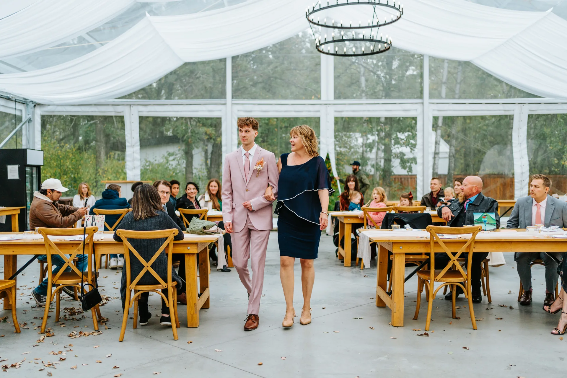 Groom Riley solo portrait in blush suit and pink tie at Oakland Estates Manitoba wedding by Chris Ngo