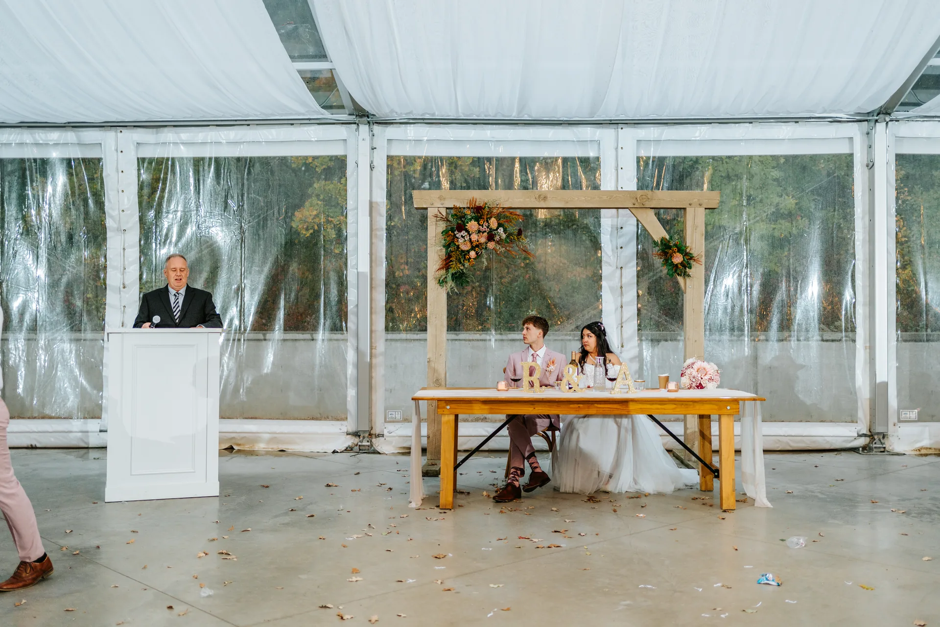 Guests on the dance floor with string lights above in the glass tent at Oakland Estates Manitoba wedding