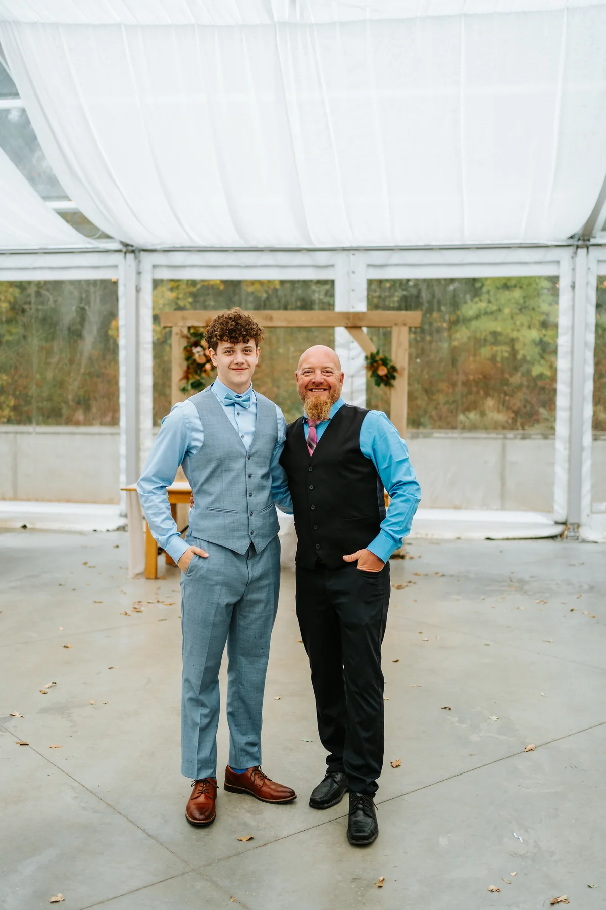Candid of guests laughing at farm tables during Oakland Estates Manitoba wedding reception