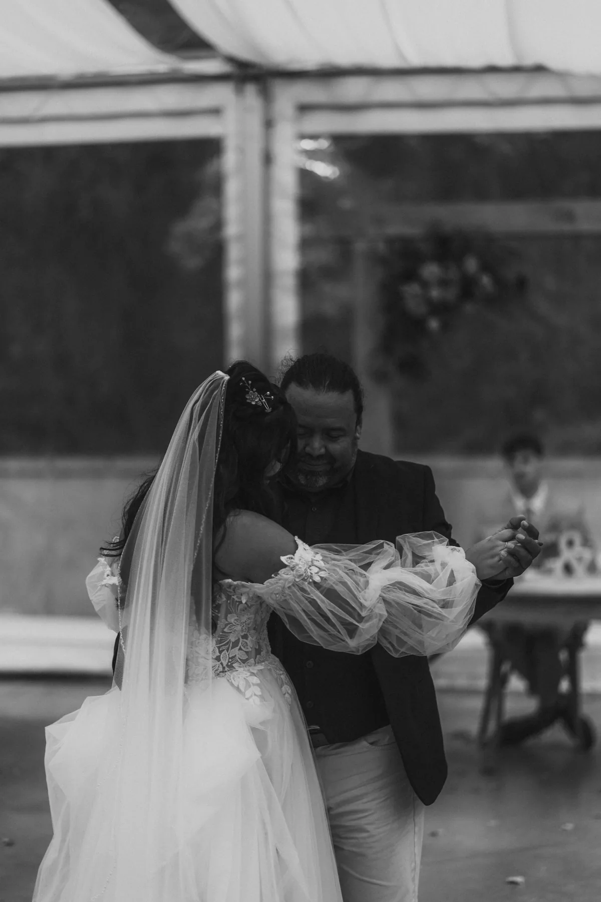 Candid reception moment with guests inside the glass tent at Oakland Estates Manitoba wedding