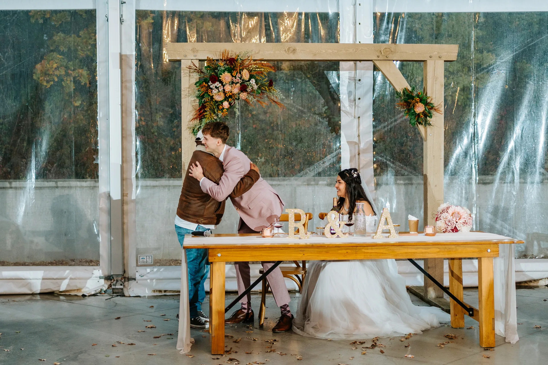 Candid reception celebration with guests in the glass tent at Oakland Estates Manitoba wedding